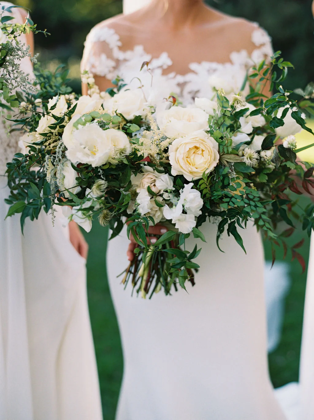 Natural, organic bridal bouquet with white garden roses, ranunculus, and lush greenery. Nashville, TN Wedding Florist.