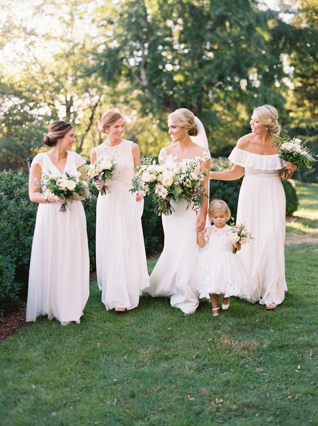 All white bridesmaid dresses with white flowers and greenery. Nashville Wedding Floral Design.
