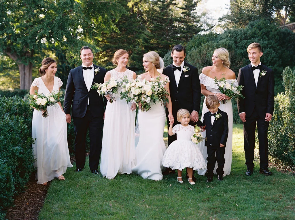 All white bridesmaid dresses with white flowers and greenery. Nashville Wedding Floral Design.