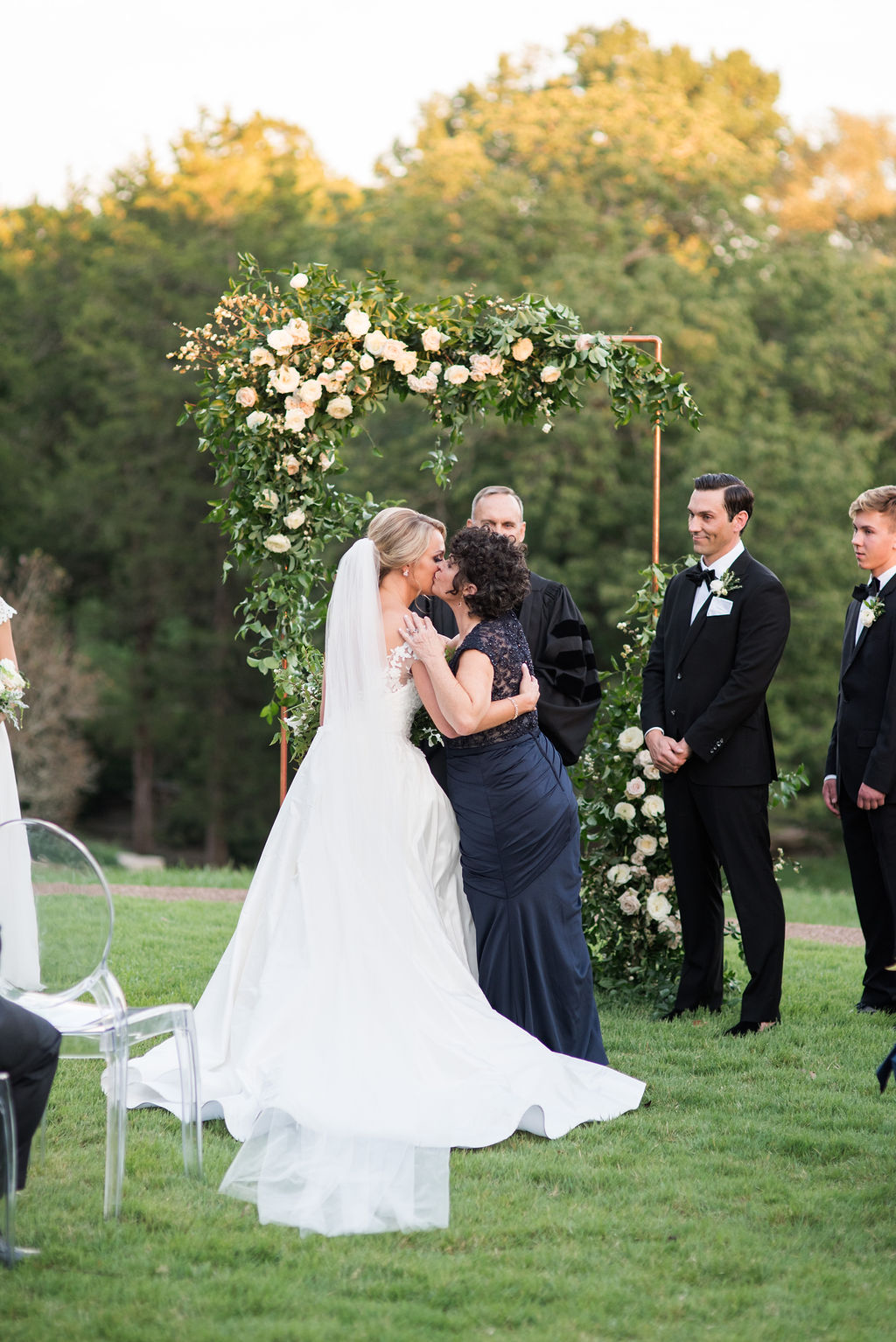 Modern copper arch with lush, garden-inspired florals and greenery. Cheekwood Wedding Flowers.