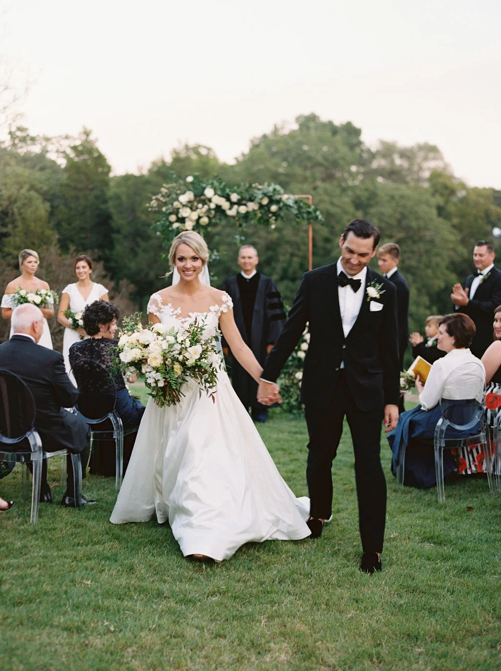 Modern copper arch with lush, garden-inspired florals and greenery. Cheekwood Wedding Flowers.