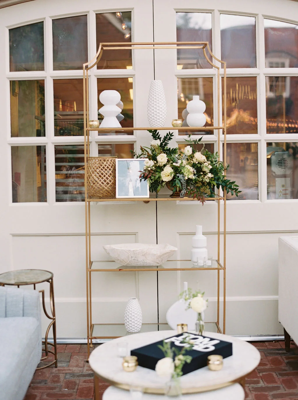 Low centerpiece with white and blush garden roses and ranunculus with natural greenery. Southeastern Wedding Floral Design