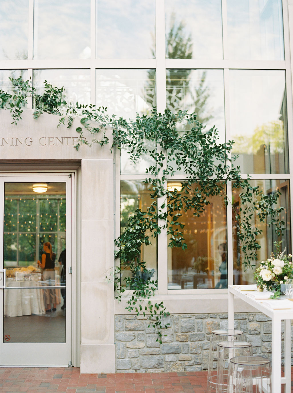 Lush, vine-like greenery growing on the window of the Frist Learning Center. Nashville Wedding Floral Design