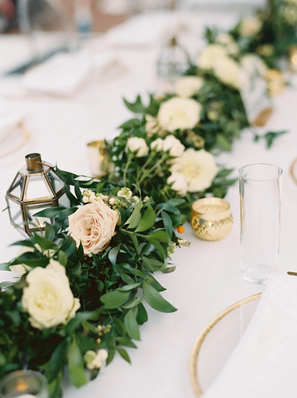 Lush garland runners with floral accents. Nashville Wedding Flowers