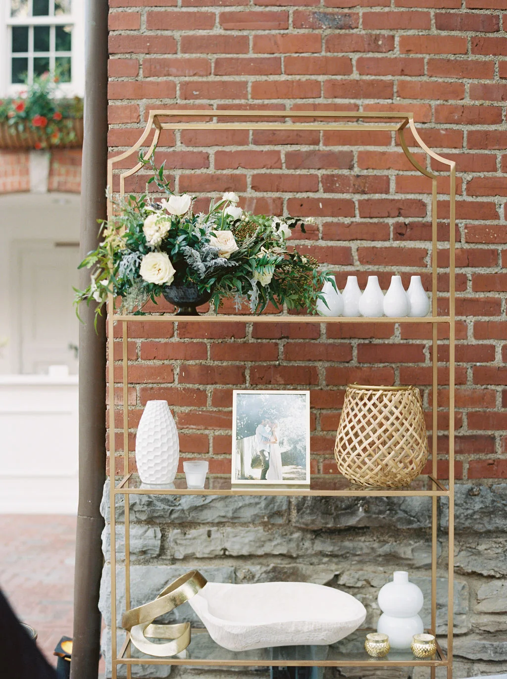 Low centerpiece with white and blush garden roses and ranunculus with natural greenery. Southeastern Wedding Floral Design