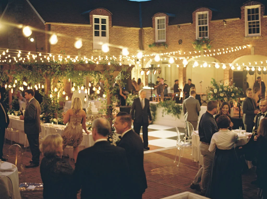 Wooden garden trellis over the head table with natural, vine-like greenery and floral garlands. Nashville Wedding Florist.