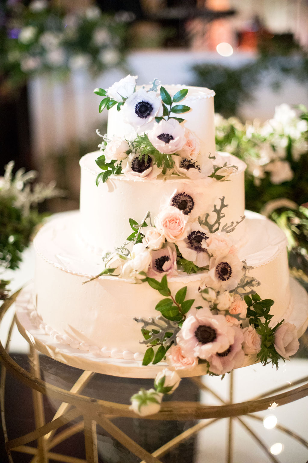 Cascading anemones and greenery for the cake. Nashville Wedding Floral Design