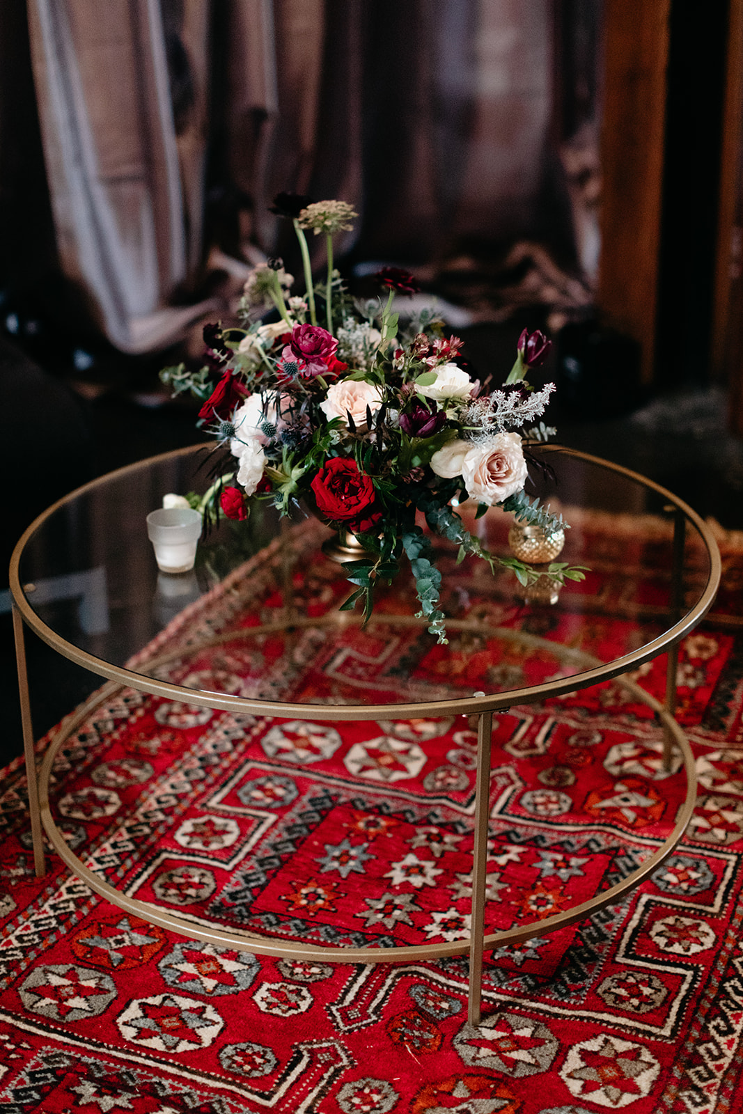 Moody, modern warehouse wedding in Nashville with Persian rugs and and lush floral design.