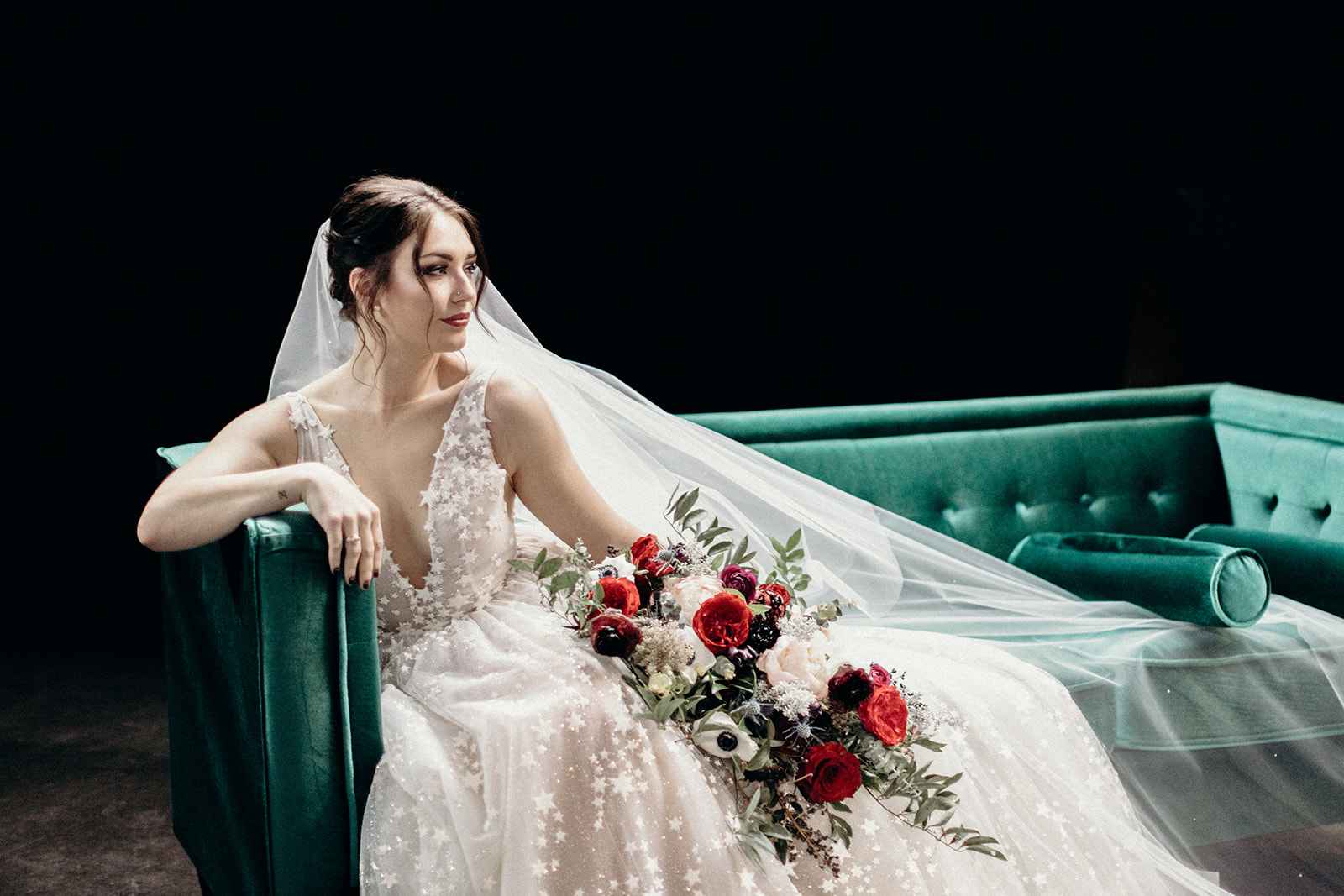 Starry wedding dress with an untamed, airy bridal bouquet with garden roses, ranunculus, and anemones in hues of burgundy and jewel tones. Bonus: green velvet couch! Wedding Floral Designer in Nashville, TN.