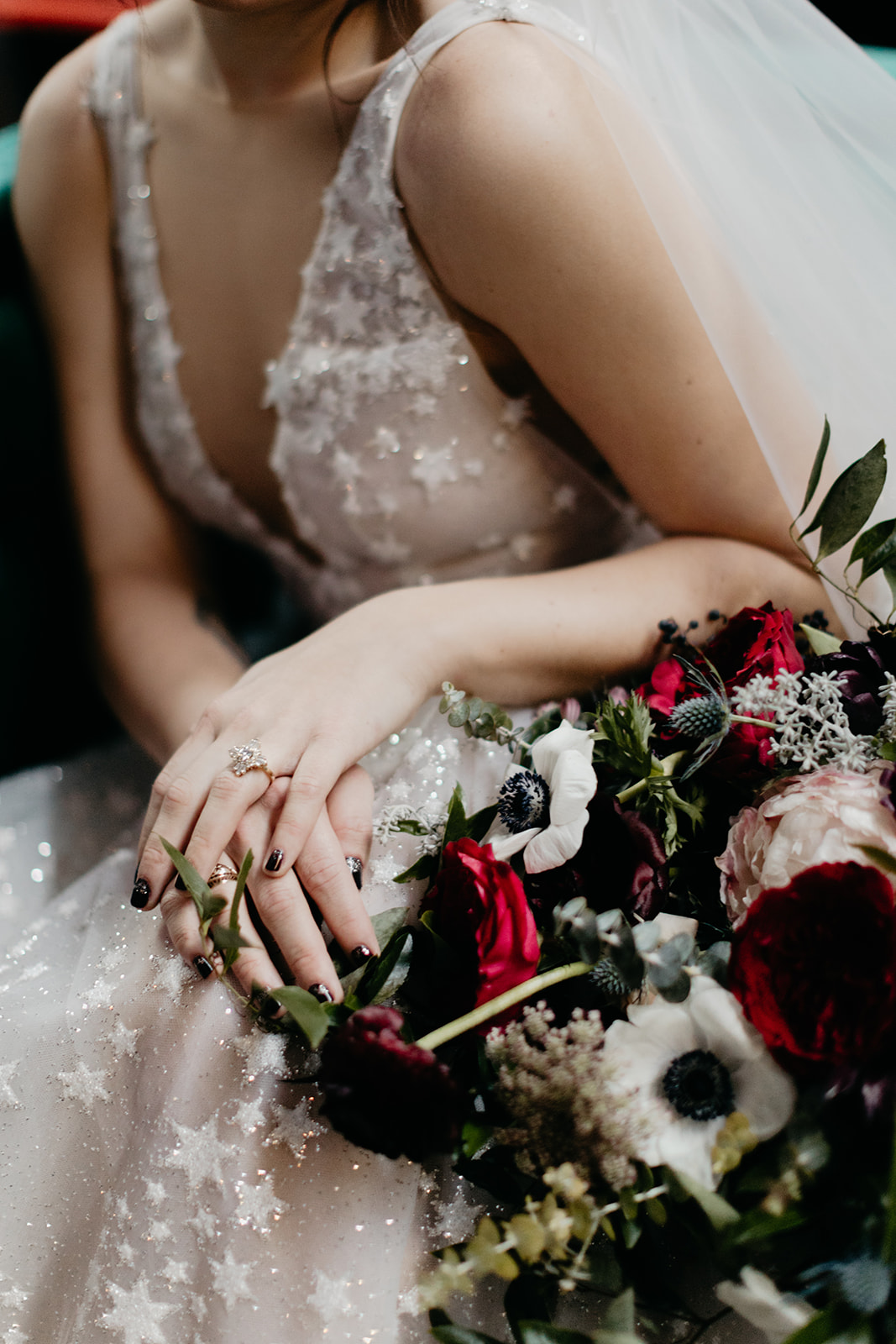 Starry wedding dress with an untamed, airy bridal bouquet with garden roses, ranunculus, and anemones in hues of burgundy and jewel tones. Bonus: green velvet couch! Wedding Floral Designer in Nashville, TN.