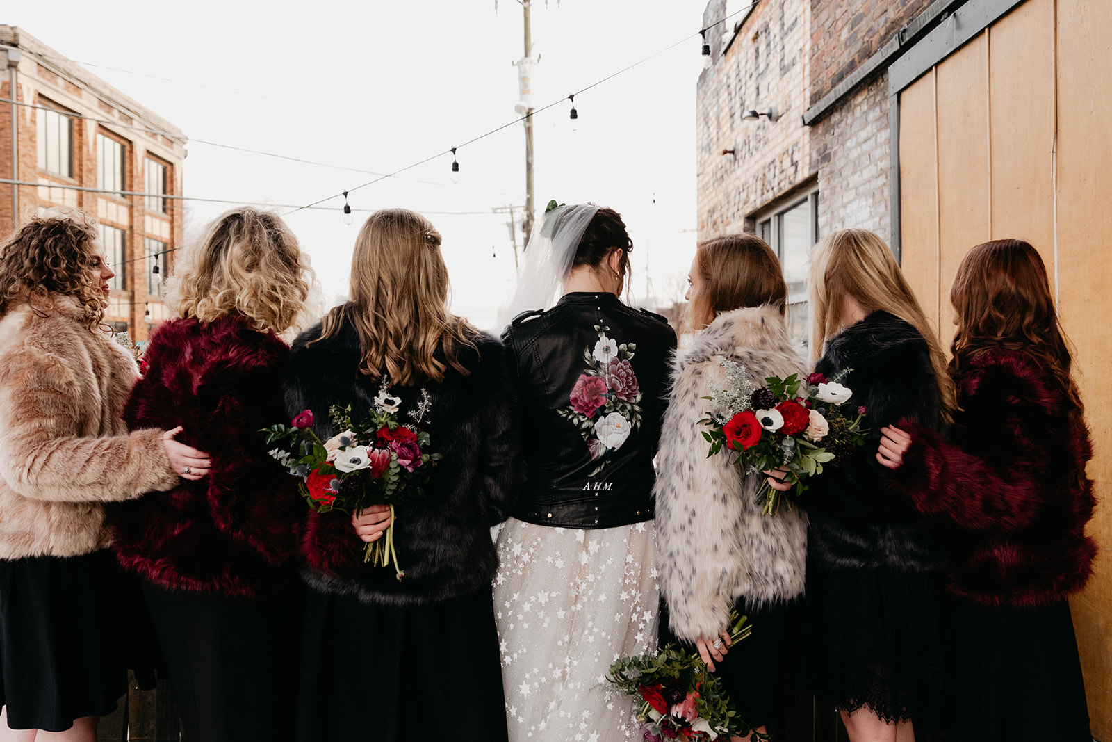 Fur coats and a custom leather jacket. Badass, edgy bridesmaid style, Nashville Wedding Florist.