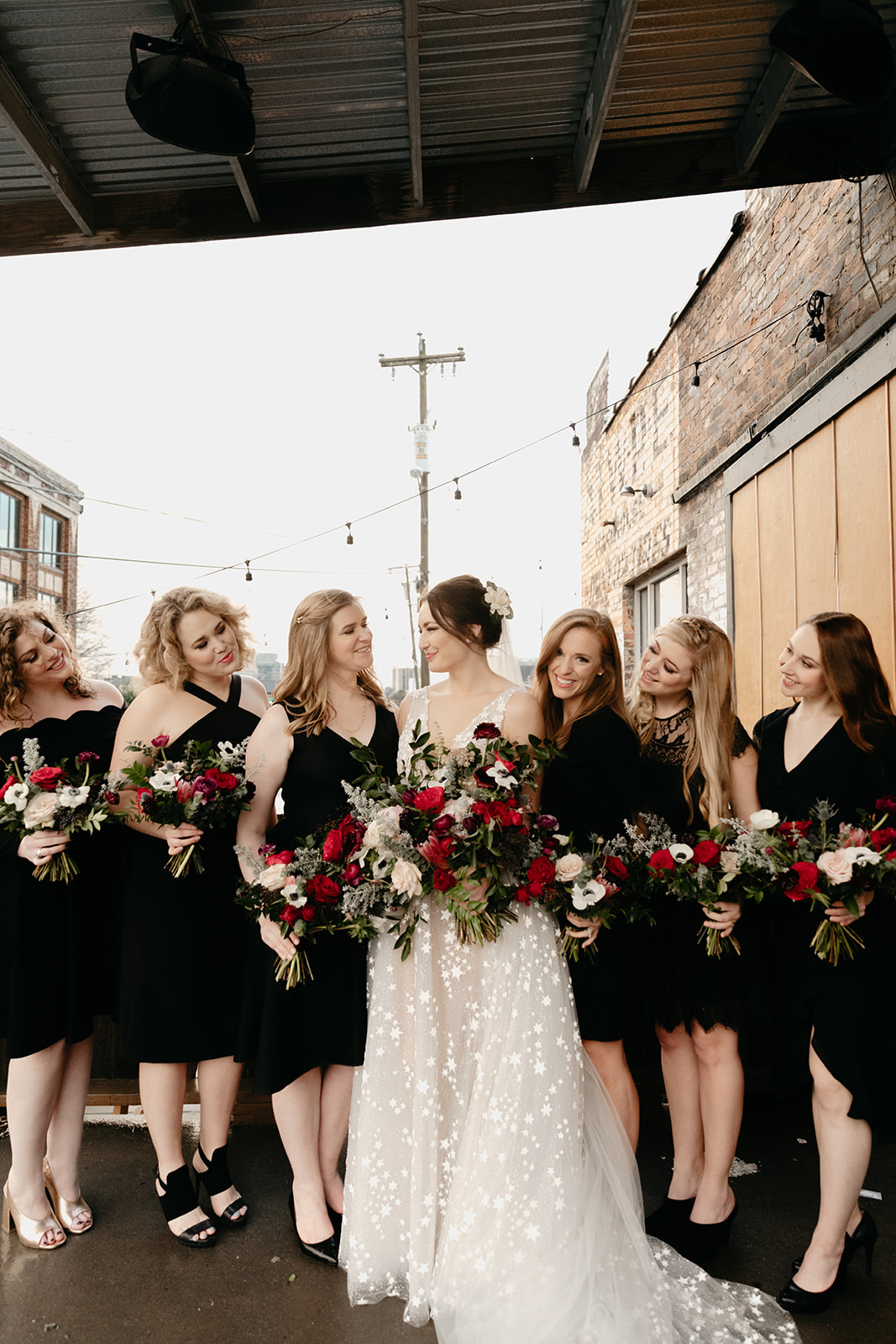 Black bridesmaid dresses with jewel tone and greenery bouquets in a natural, garden-inspired floral style. Nashville Wedding Florist.