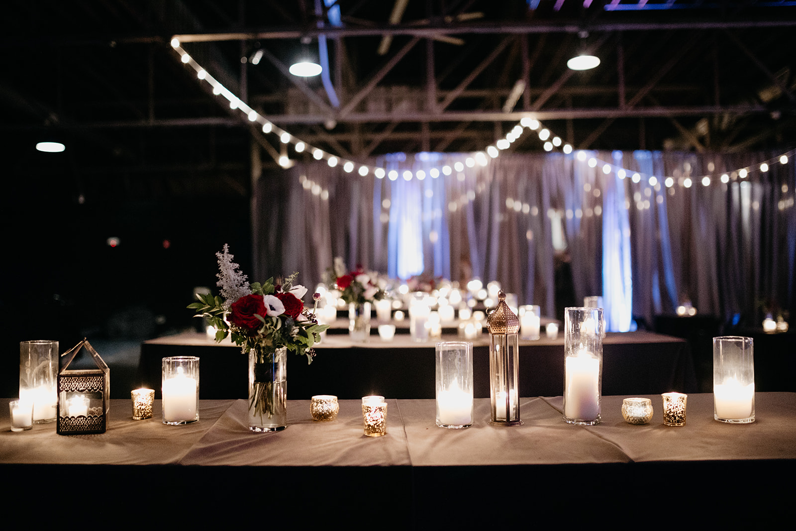 Candlelit wedding reception with marsala and burgundy florals. Real January Wedding at Marathon Music Works!