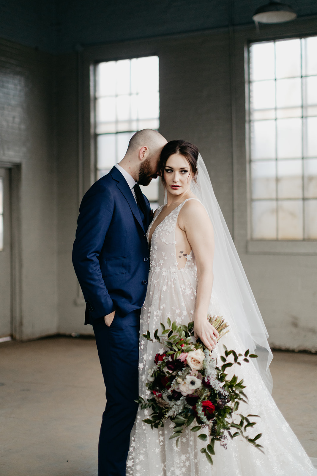Starry wedding dress with an untamed, airy bridal bouquet with garden roses, ranunculus, and anemones in hues of burgundy and jewel tones. Wedding Floral Designer in Nashville, TN.
