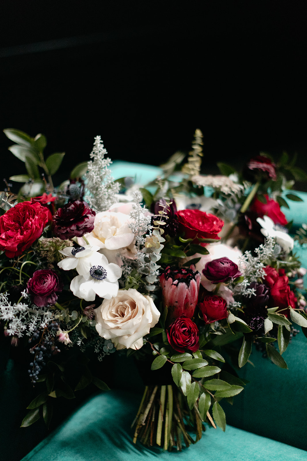Lush, wintry bridal bouquet with garden roses, anemones, ranunculus, and greenery. Nashville Wedding Florist.
