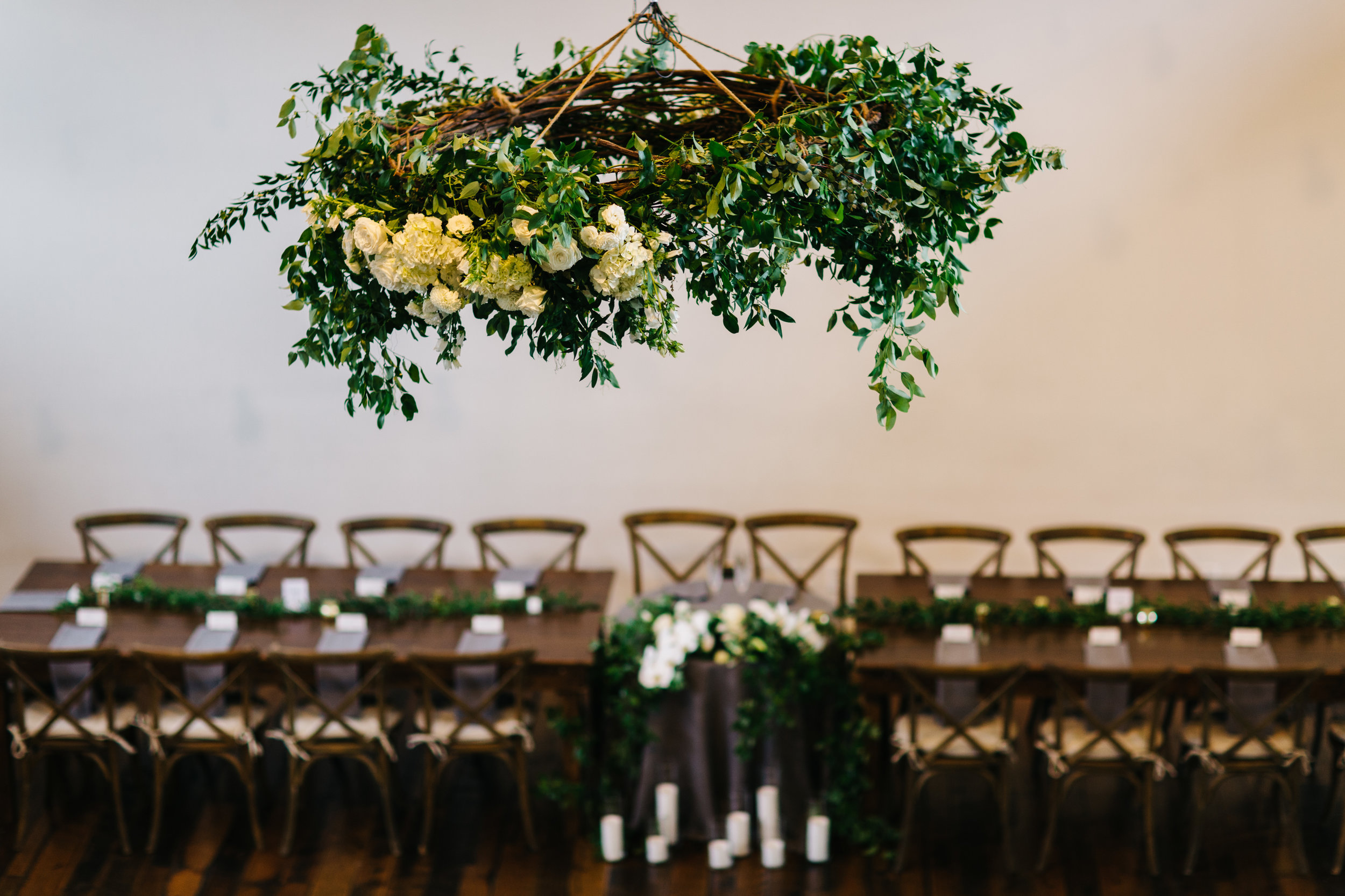 Lush greenery chandelier with all white florals over the dance floor. Nashville Wedding Florist.