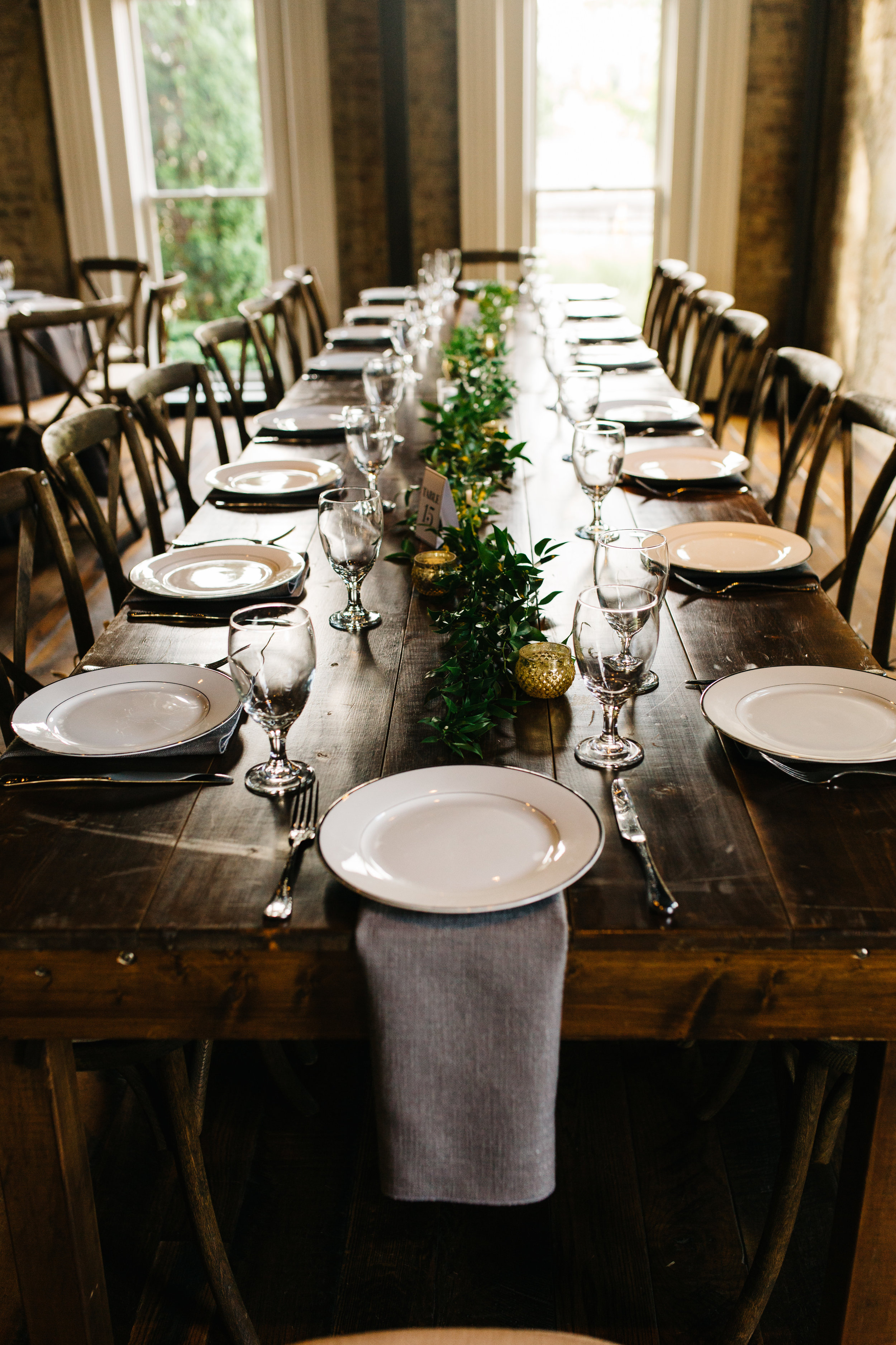 Greenery garlands running the length of each farm table. Nashville Wedding Florist at the Cordelle.