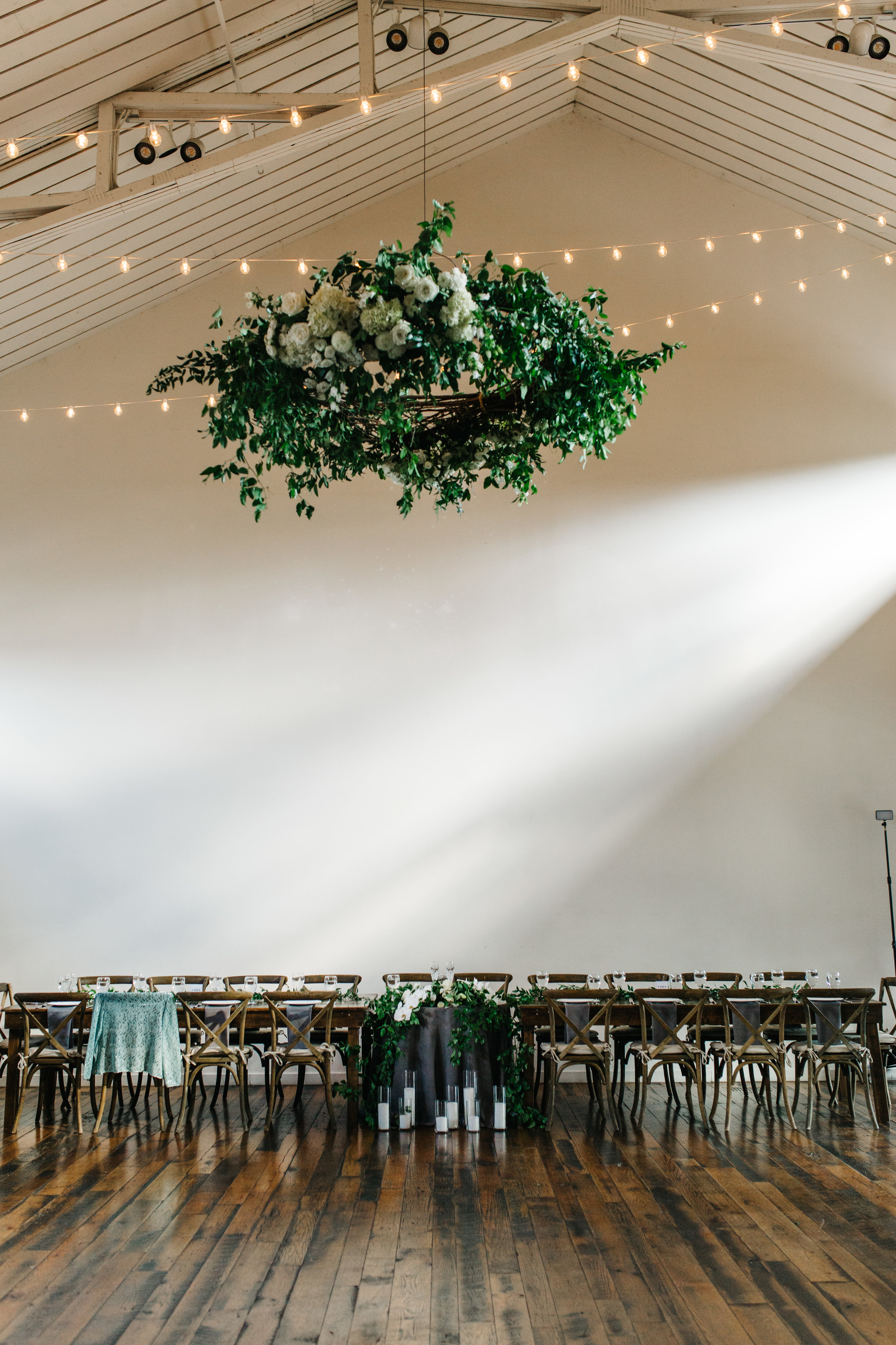 Lush greenery chandelier with all white florals over the dance floor. Nashville Wedding Florist.