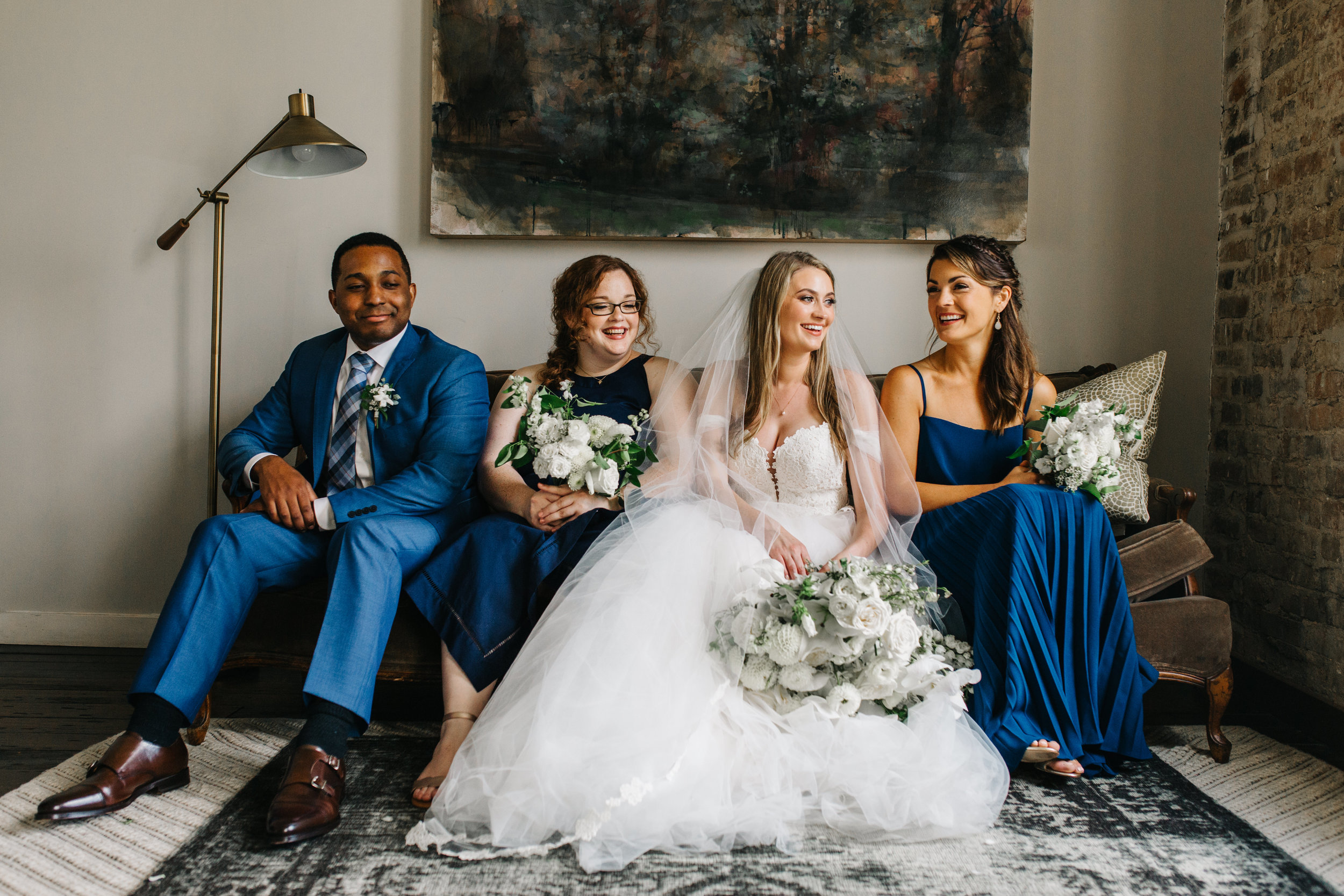 Blue bridal party style with all white, greenery heavy, organic floral design style. Southern Wedding Florist.