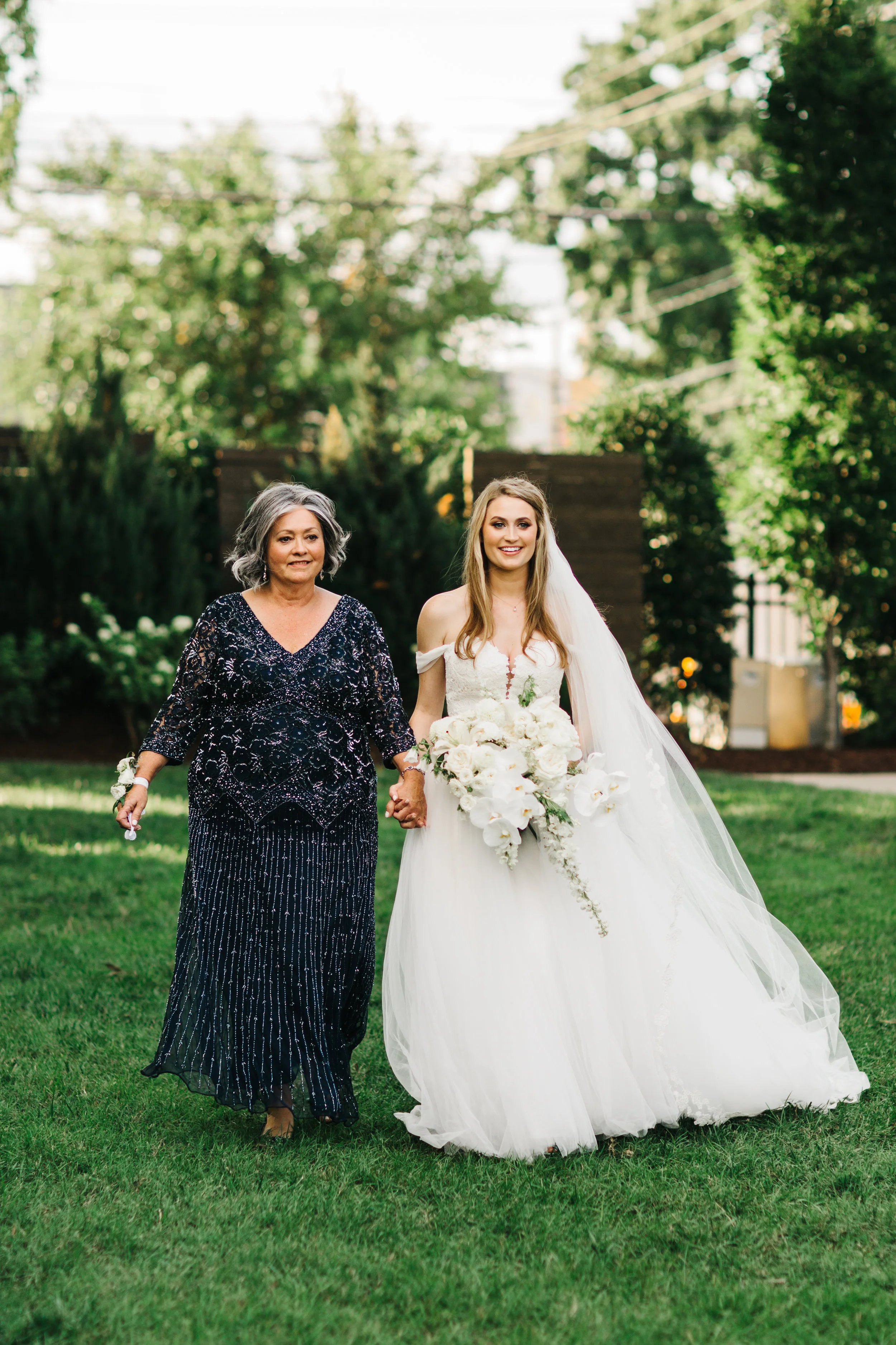 Mother of the Bride walking the bride down the aisle. Nashville Wedding Floral Design.