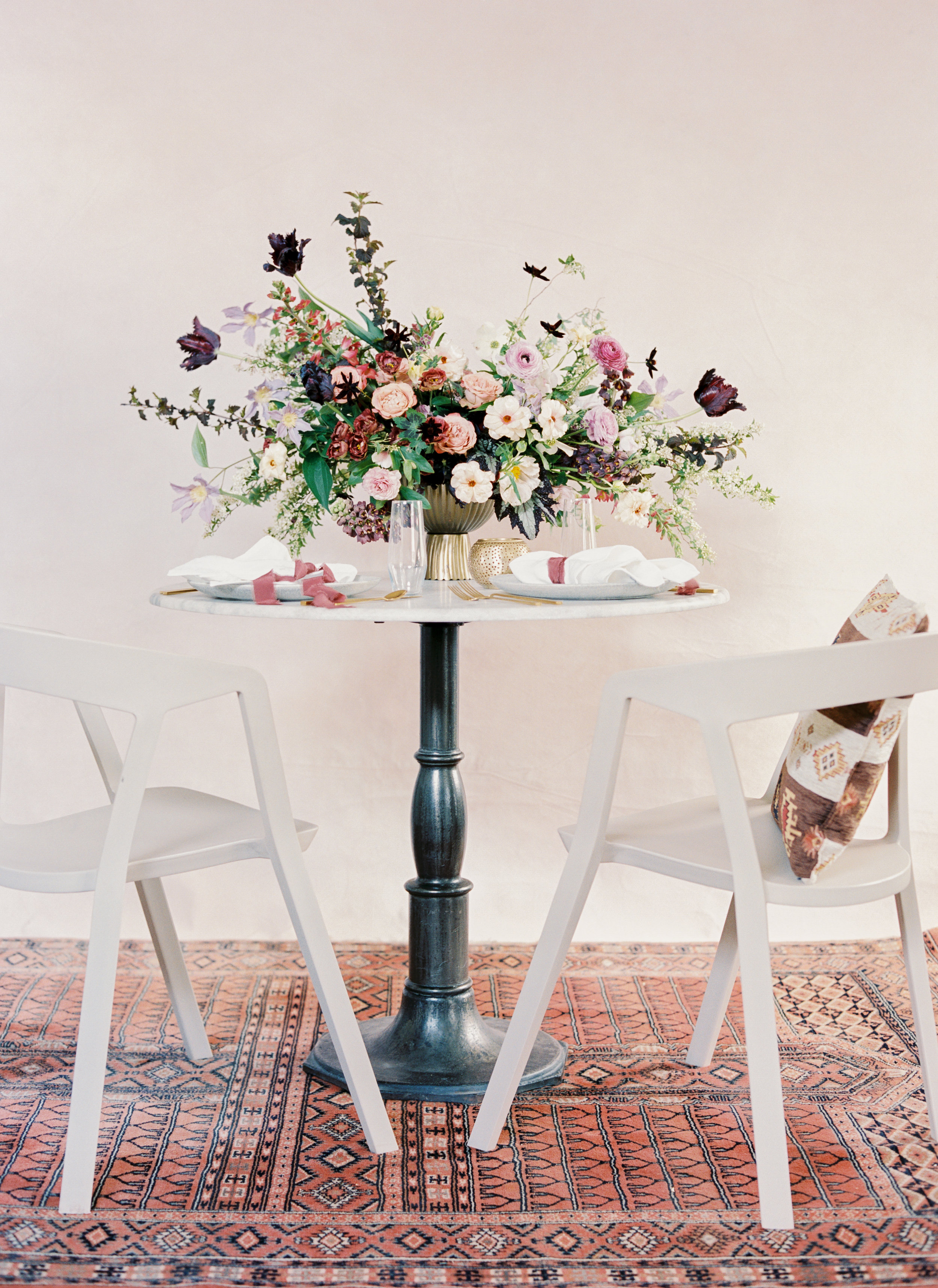 Moroccan rug, marble table, and flowers in shades of mauve, terra cotta, and eggplant. April wedding color palette by Nashville floral designer, Rosemary and Finch.