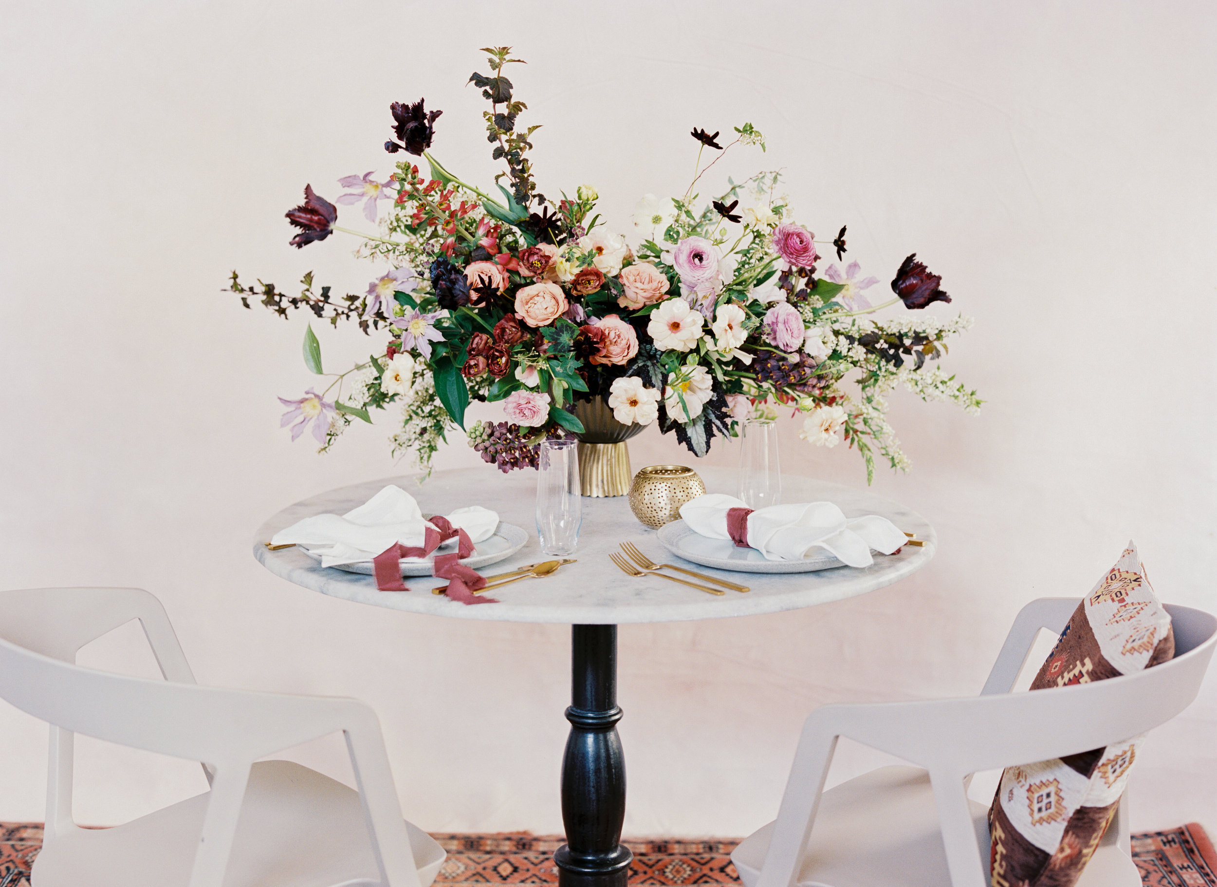 Moroccan rug, marble table, and flowers in shades of mauve, terra cotta, and eggplant. April wedding color palette by Nashville floral designer, Rosemary and Finch.