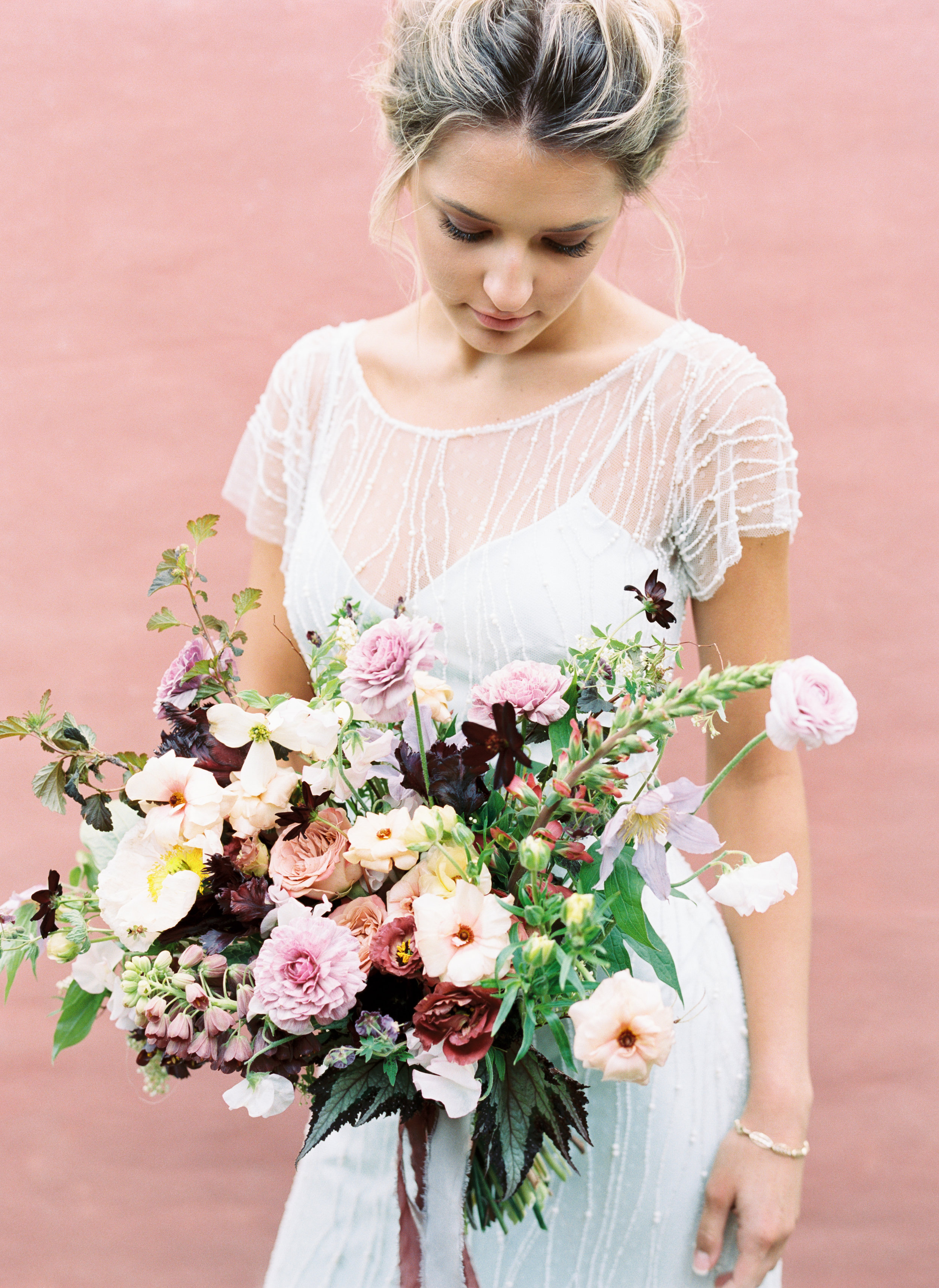 Spring bridal bouquet composed of mauve ranunculus, butterfly ranunculus, fritillaria, Icelandic poppies, sweet peas, and organic greenery. Nashville Wedding Floral Design.
