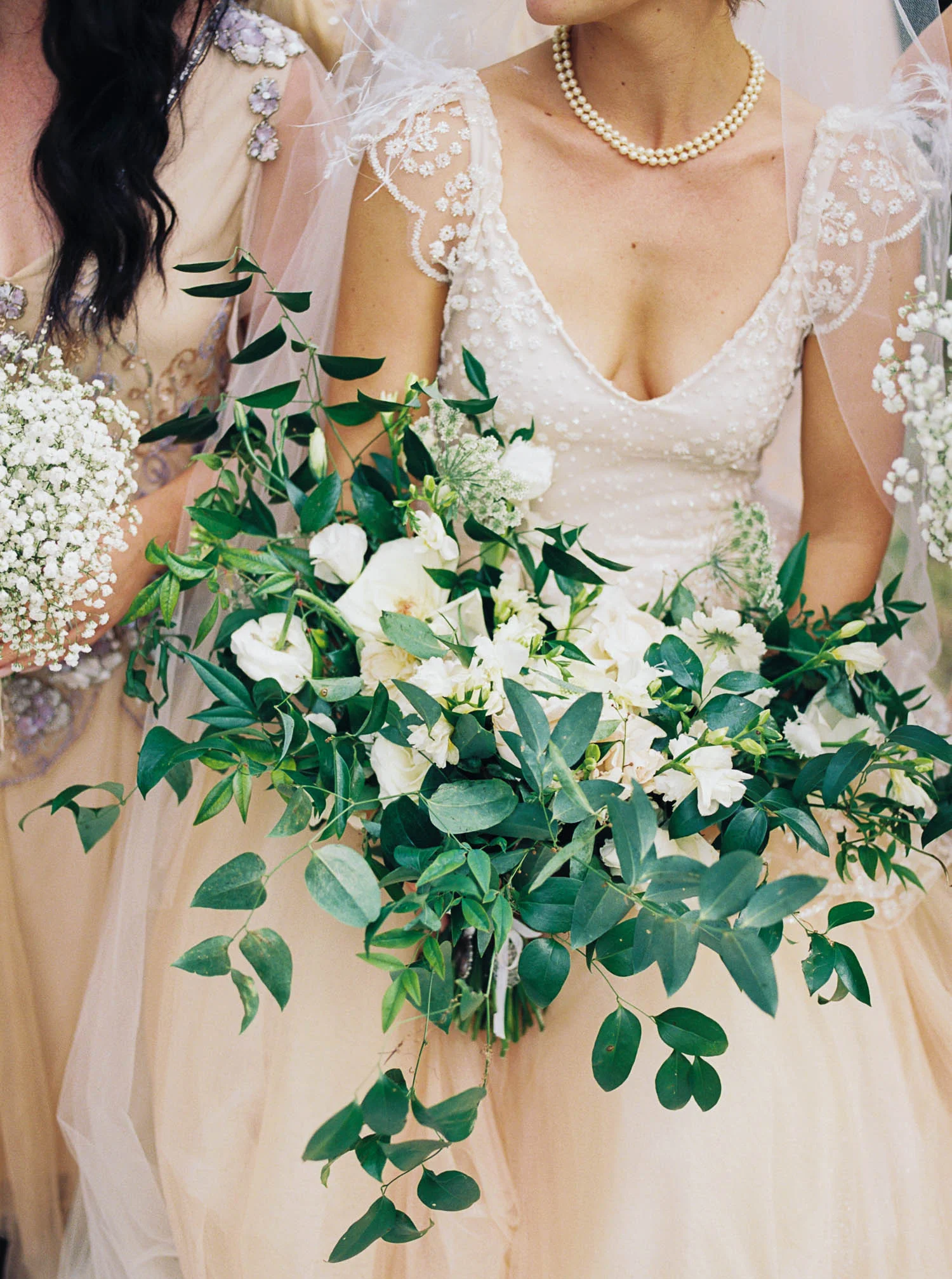 Garden-inspired bridal bouquet with garden roses, ranunculus, and lush, trailing greenery. Nashville Wedding Floral Design.