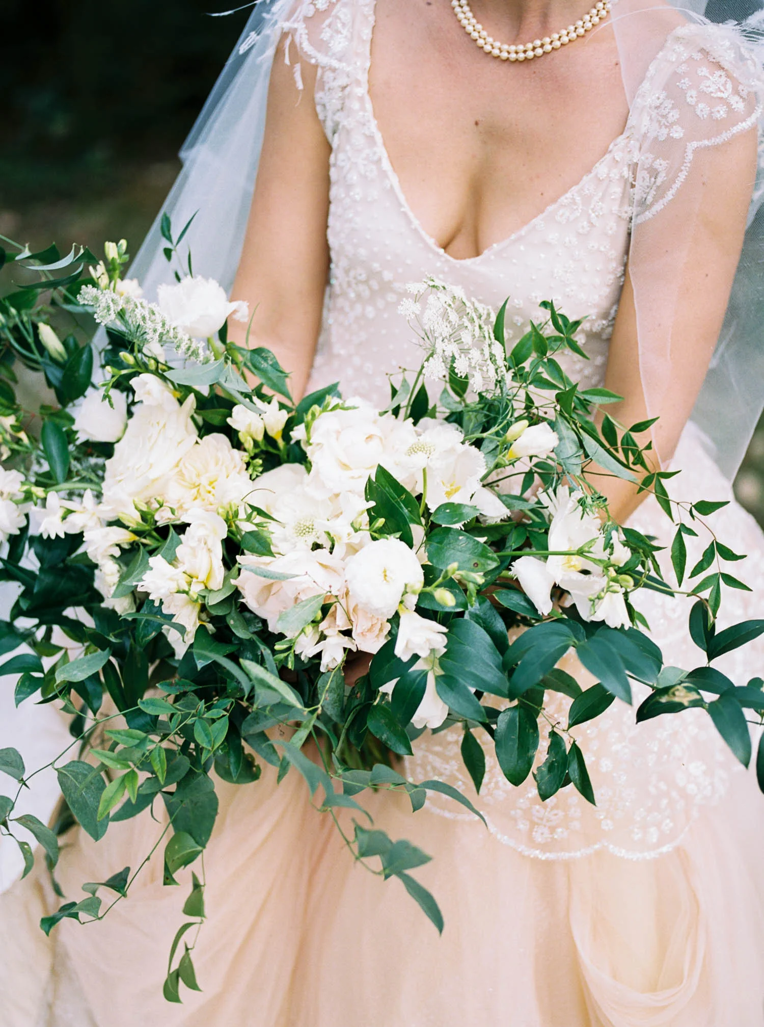 Garden-inspired bridal bouquet with garden roses, ranunculus, and lush, trailing greenery. Nashville Wedding Floral Design.