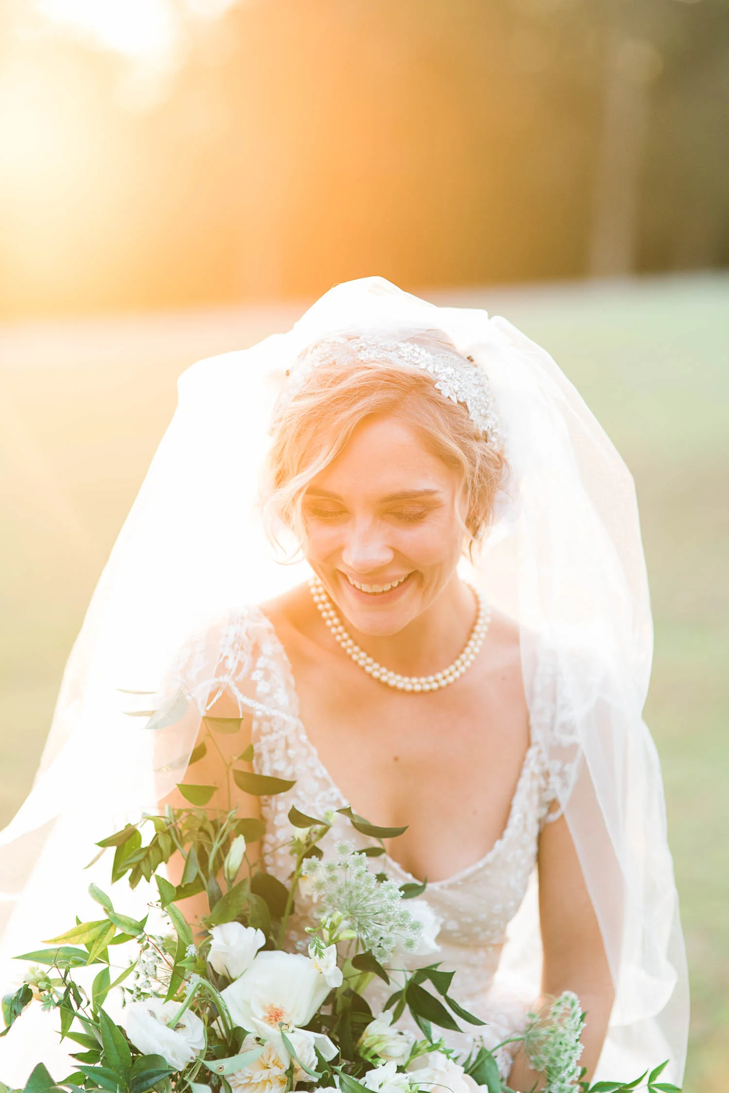 Blush wedding dress with asymmetrical, trailing floral design in Nashville, TN.