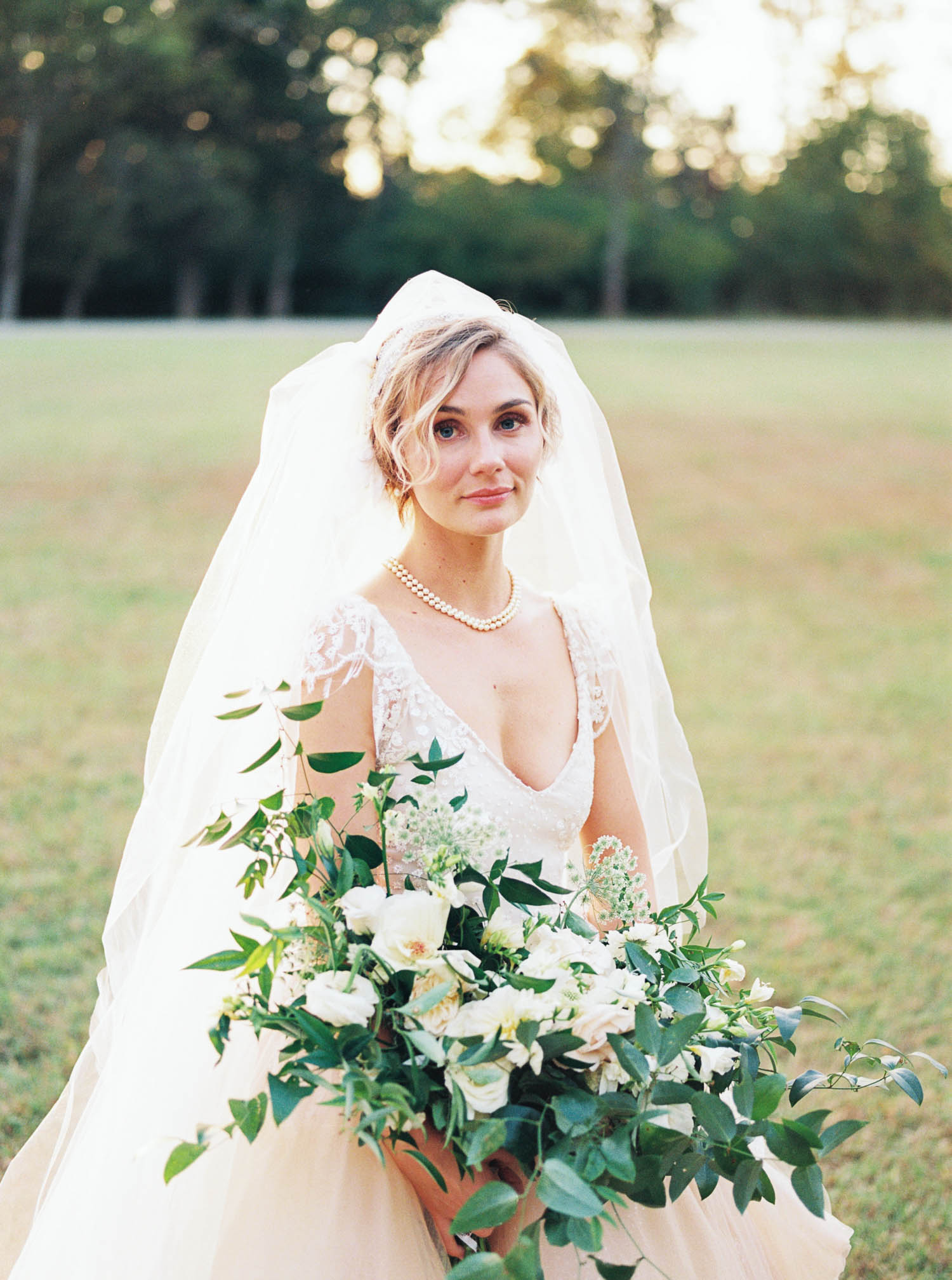 Blush wedding dress with asymmetrical, trailing floral design in Nashville, TN.