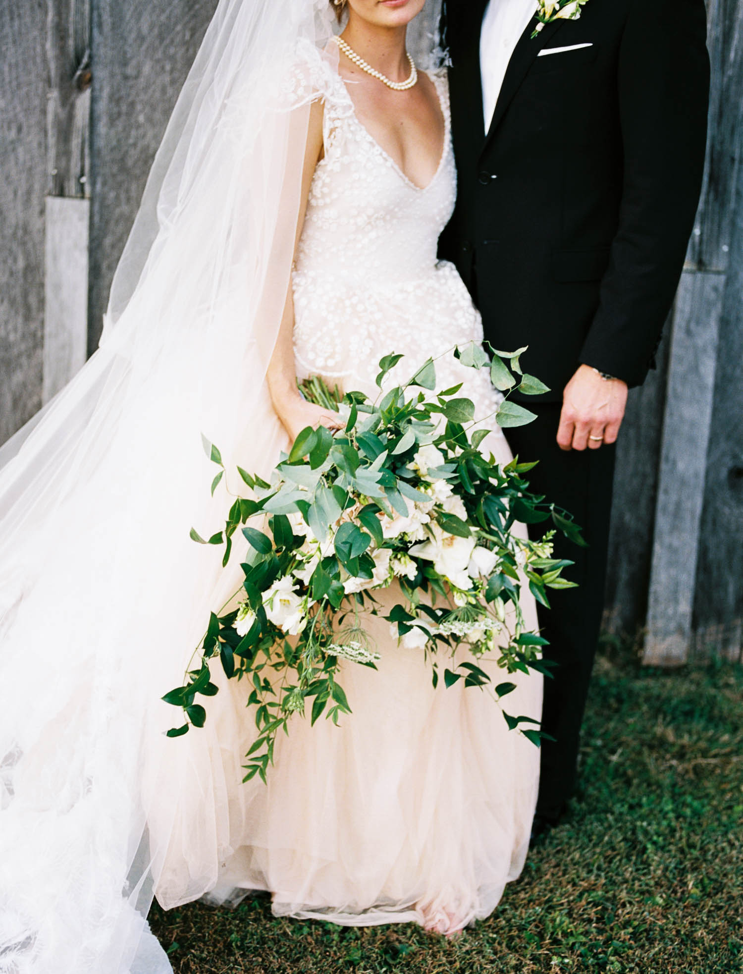 Blush wedding dress with asymmetrical, trailing floral design in Nashville, TN.