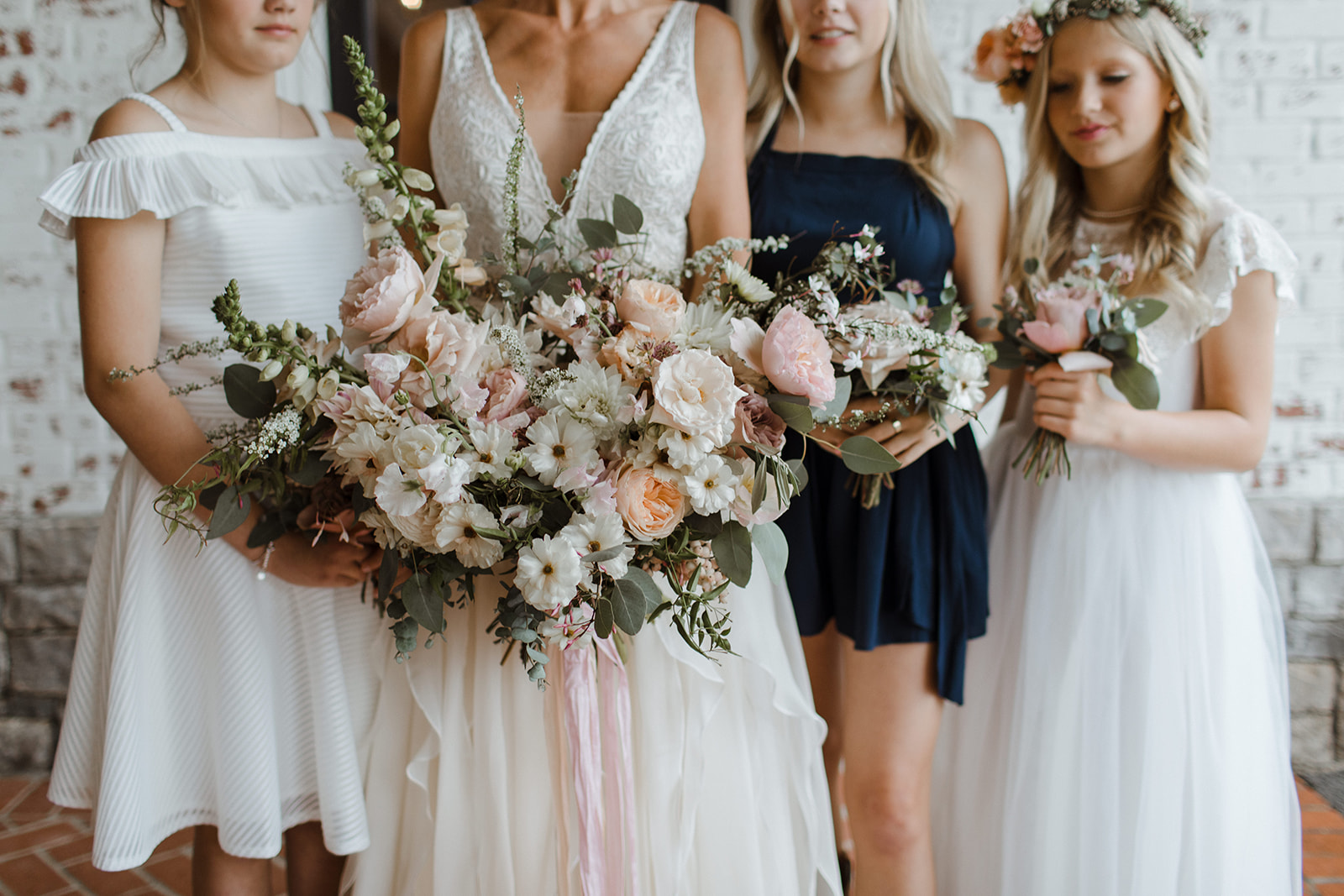 Lush, asymmetrical blush and neutral bridal bouquet with garden roses, ranunculus, and eucalyptus. Nashville Wedding Florist.