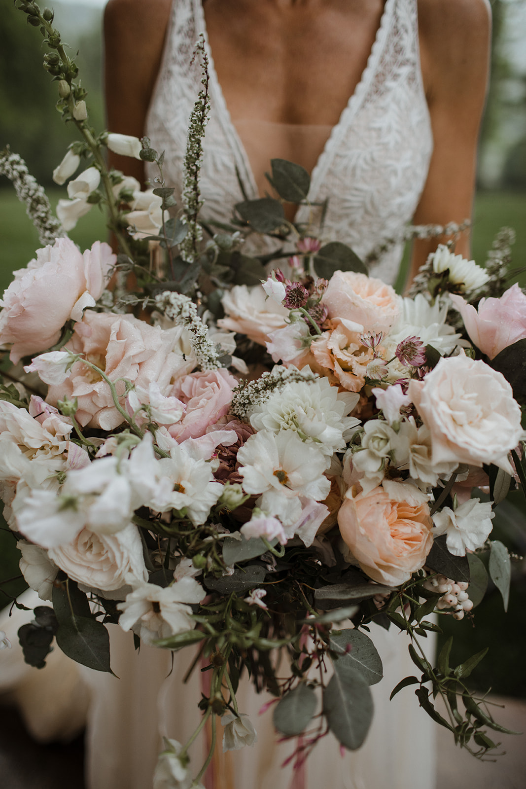 Lush, asymmetrical blush and neutral bridal bouquet with garden roses, ranunculus, and eucalyptus. Nashville Wedding Florist.
