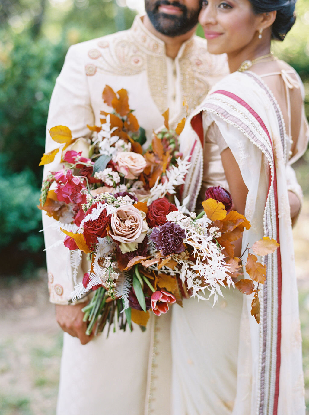 Copper, mauve, and marsala Indian bridal bouquet with white ferns, garden roses, sweet peas, and tulips. Nashville Wedding Floral Design.