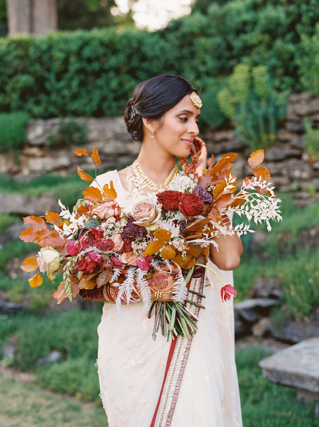 Copper, mauve, and marsala Indian bridal bouquet with white ferns, garden roses, sweet peas, and tulips. Nashville Wedding Floral Design.