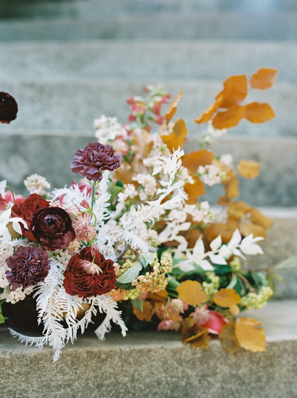 Low centerpiece with a mauve, rust, and burgundy color palette for an Indian wedding at Cheekwood Botanical Gardens. Nashville Wedding Florist.