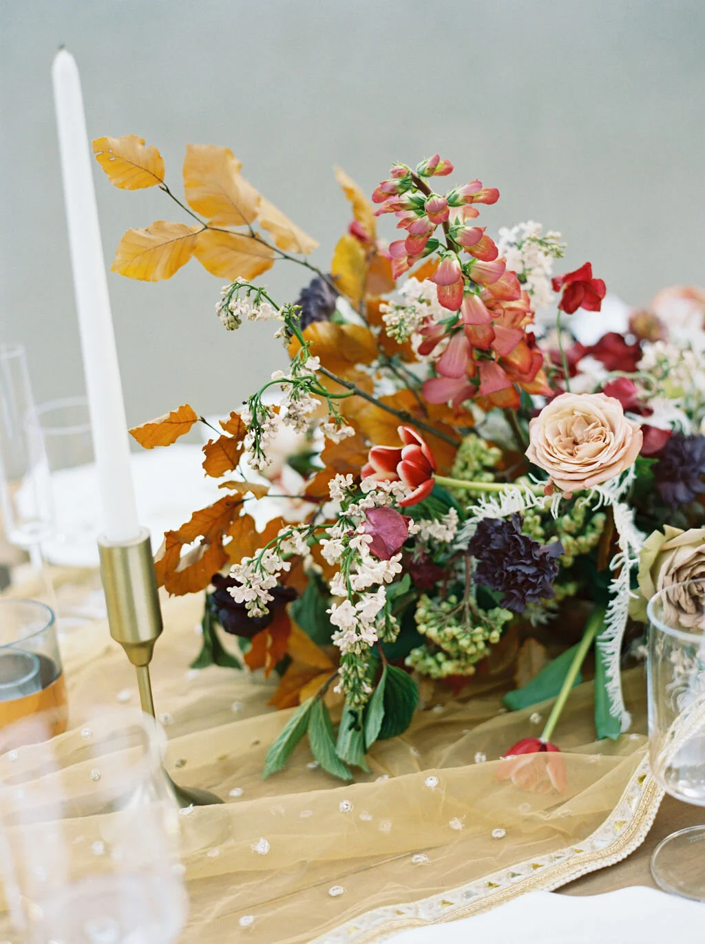 Low centerpiece with a mauve, rust, and burgundy color palette for an Indian wedding at Cheekwood Botanical Gardens. Nashville Wedding Florist.