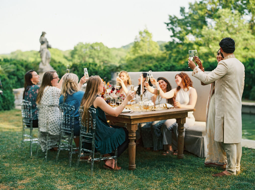 Low centerpiece with a mauve, rust, and burgundy color palette for an Indian wedding at Cheekwood Botanical Gardens. Nashville Wedding Florist.