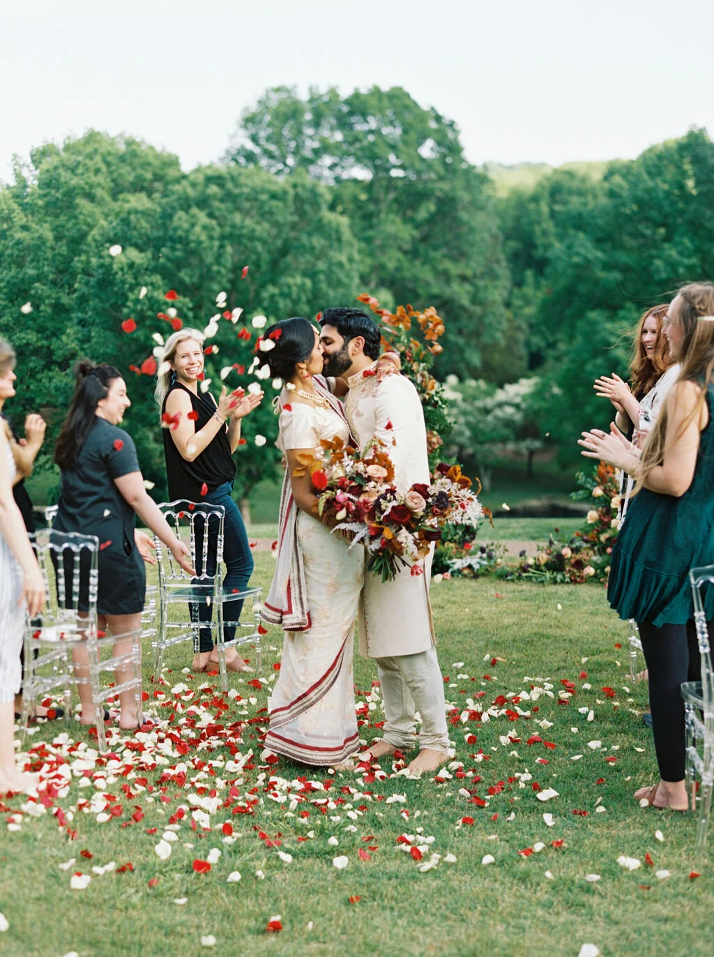 Freestanding wedding ceremony backdrop with lush greenery and bright flowers. Rose petal toss at the end of the wedding ceremony.Nashville wedding floral design by Rosemary & Finch.