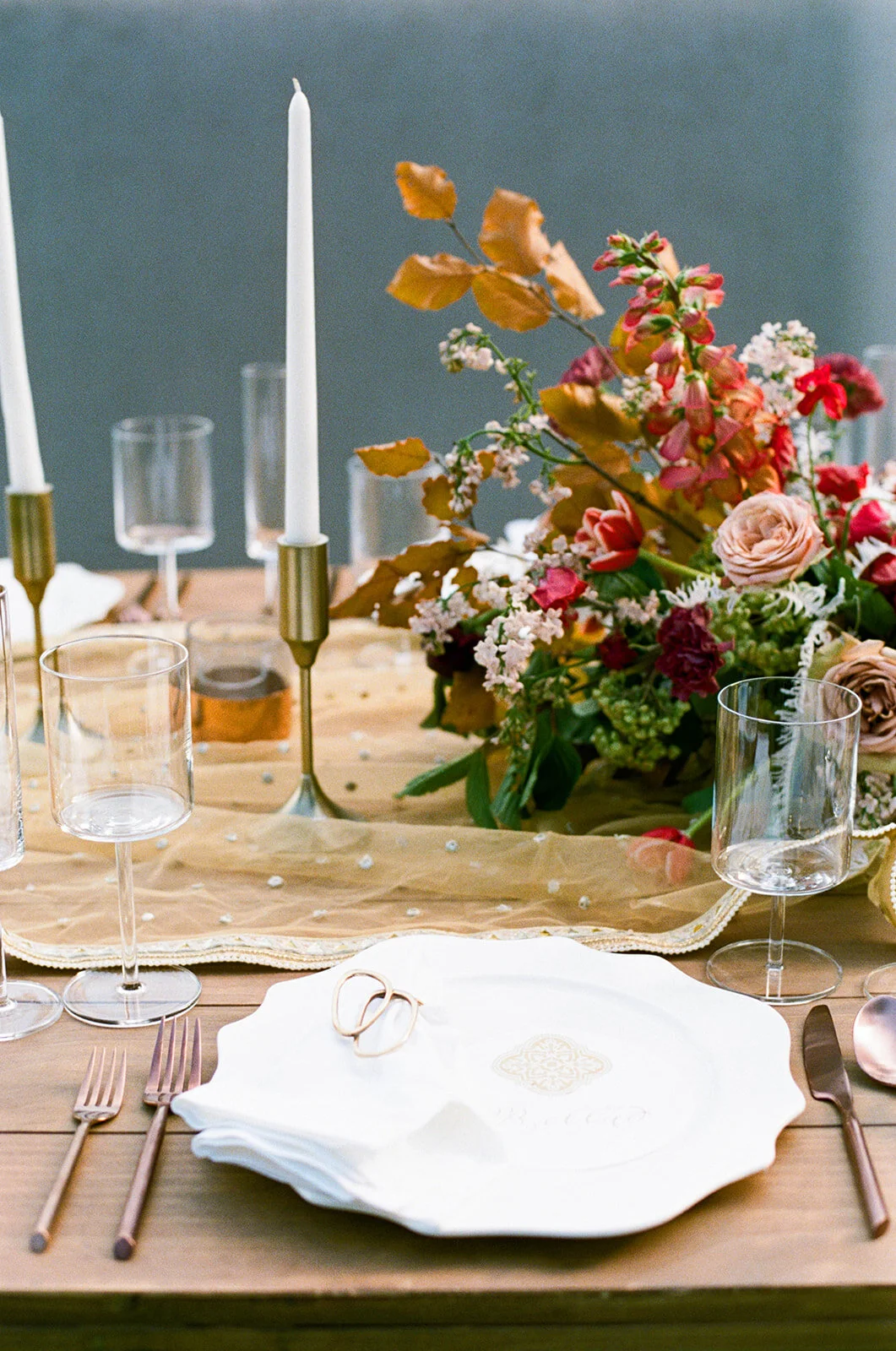 Low centerpiece with a mauve, rust, and burgundy color palette for an Indian wedding at Cheekwood Botanical Gardens. Nashville Wedding Florist.