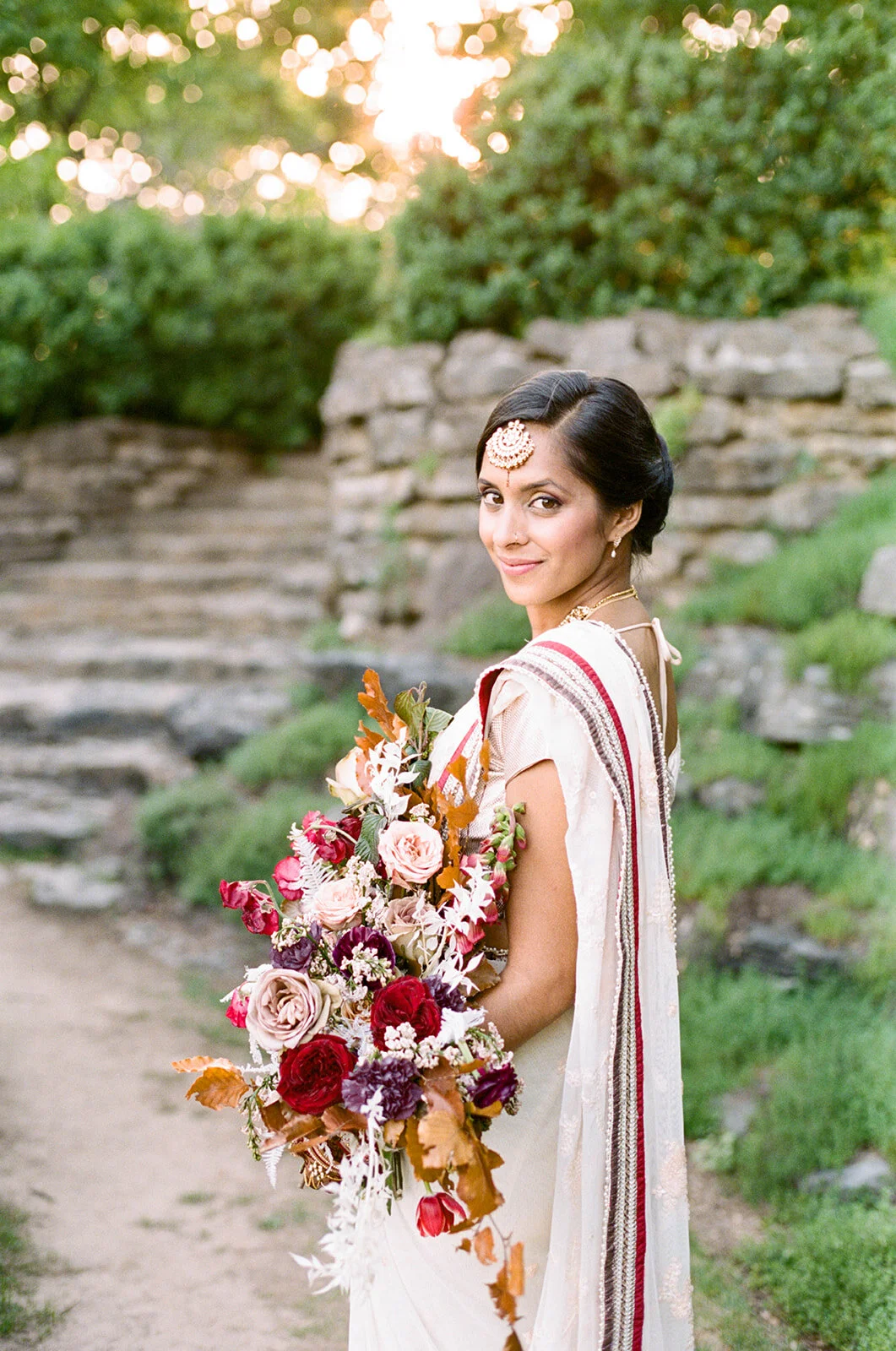 Copper, mauve, and marsala Indian bridal bouquet with white ferns, garden roses, sweet peas, and tulips. Nashville Wedding Floral Design.