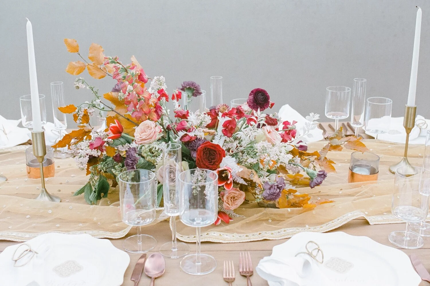 Low centerpiece with a mauve, rust, and burgundy color palette for an Indian wedding at Cheekwood Botanical Gardens. Nashville Wedding Florist.