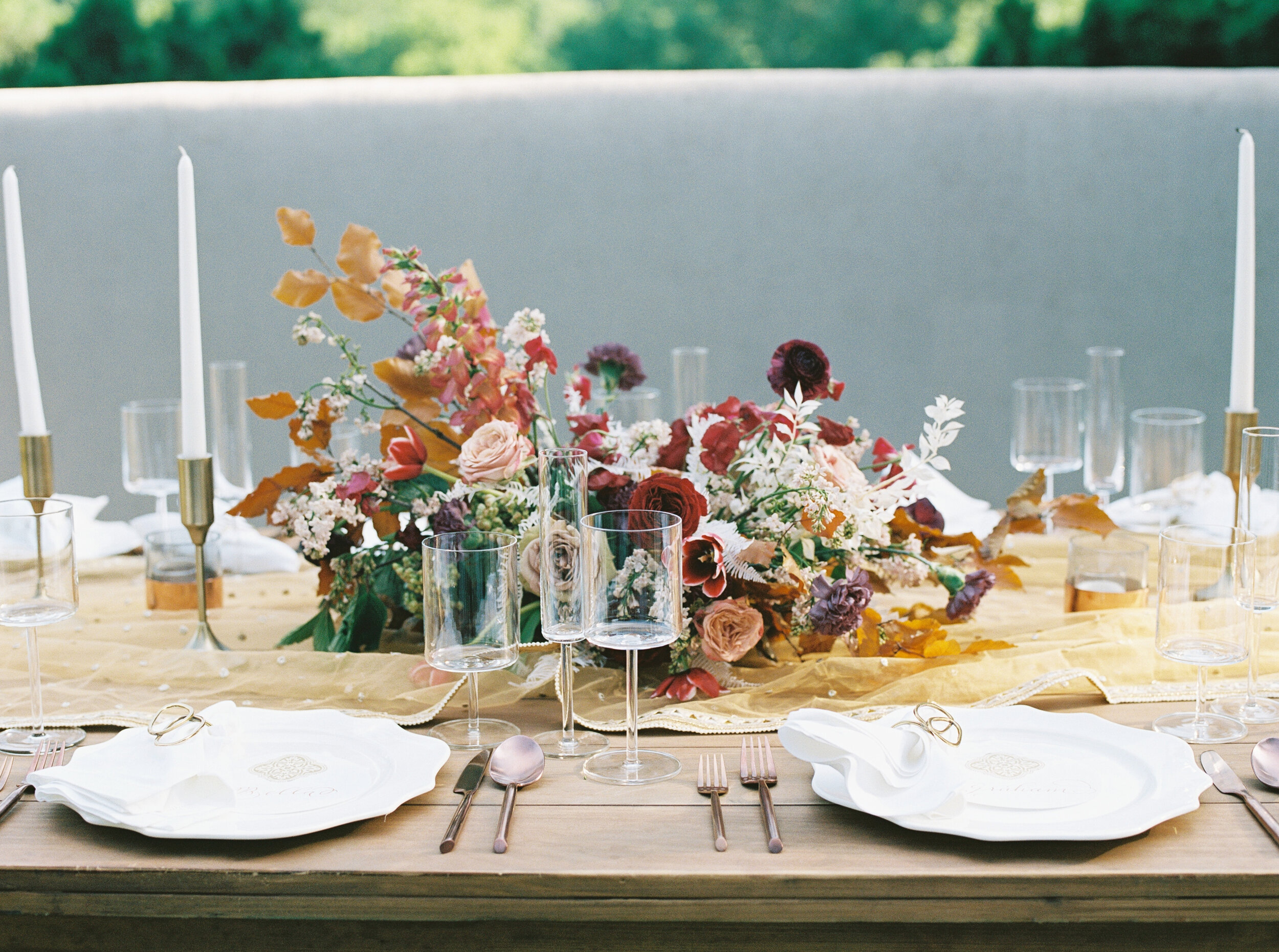 Low centerpiece with a mauve, rust, and burgundy color palette for an Indian wedding at Cheekwood Botanical Gardens. Nashville Wedding Florist.