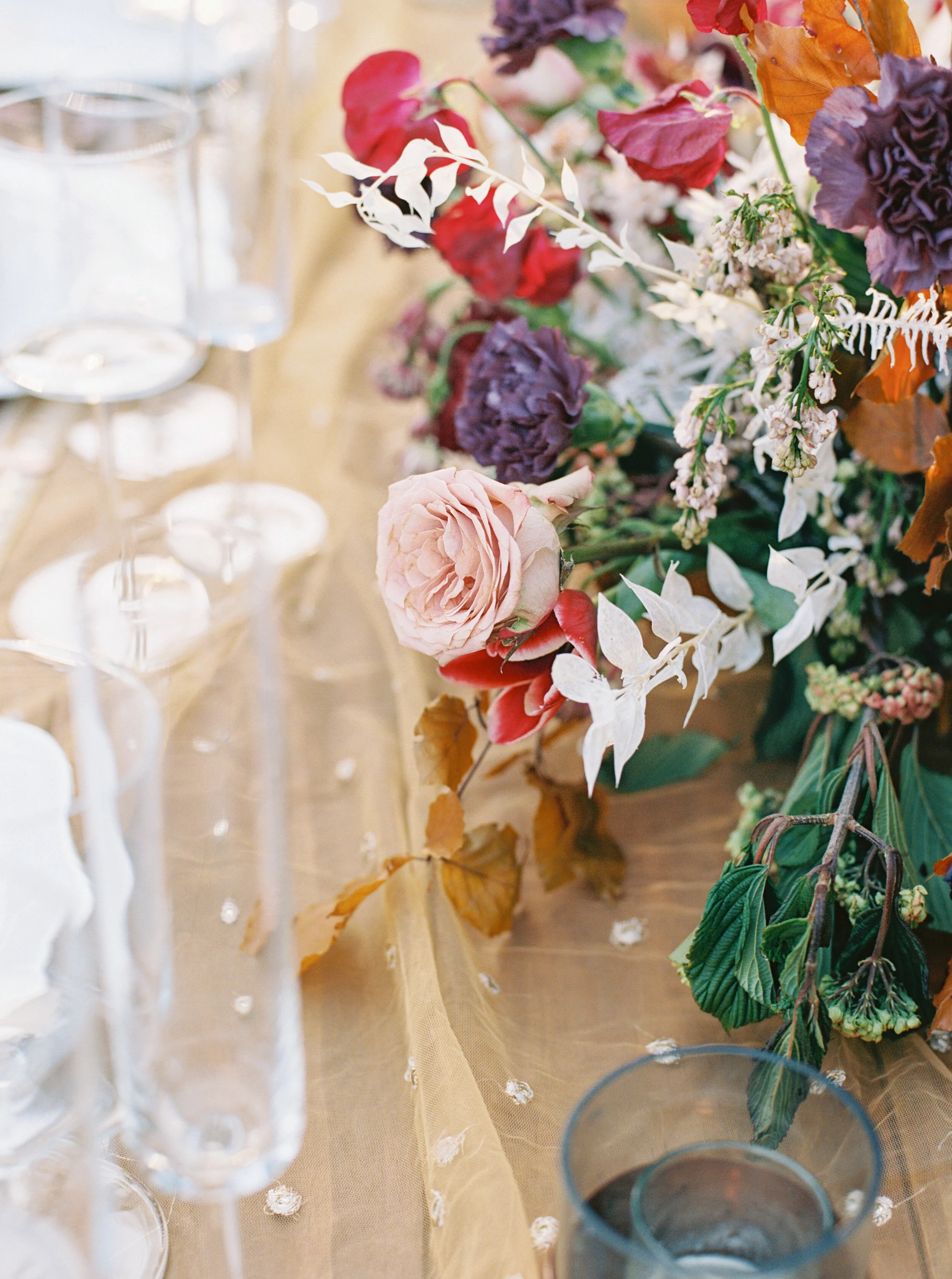 Low centerpiece with a mauve, rust, and burgundy color palette for an Indian wedding at Cheekwood Botanical Gardens. Nashville Wedding Florist.
