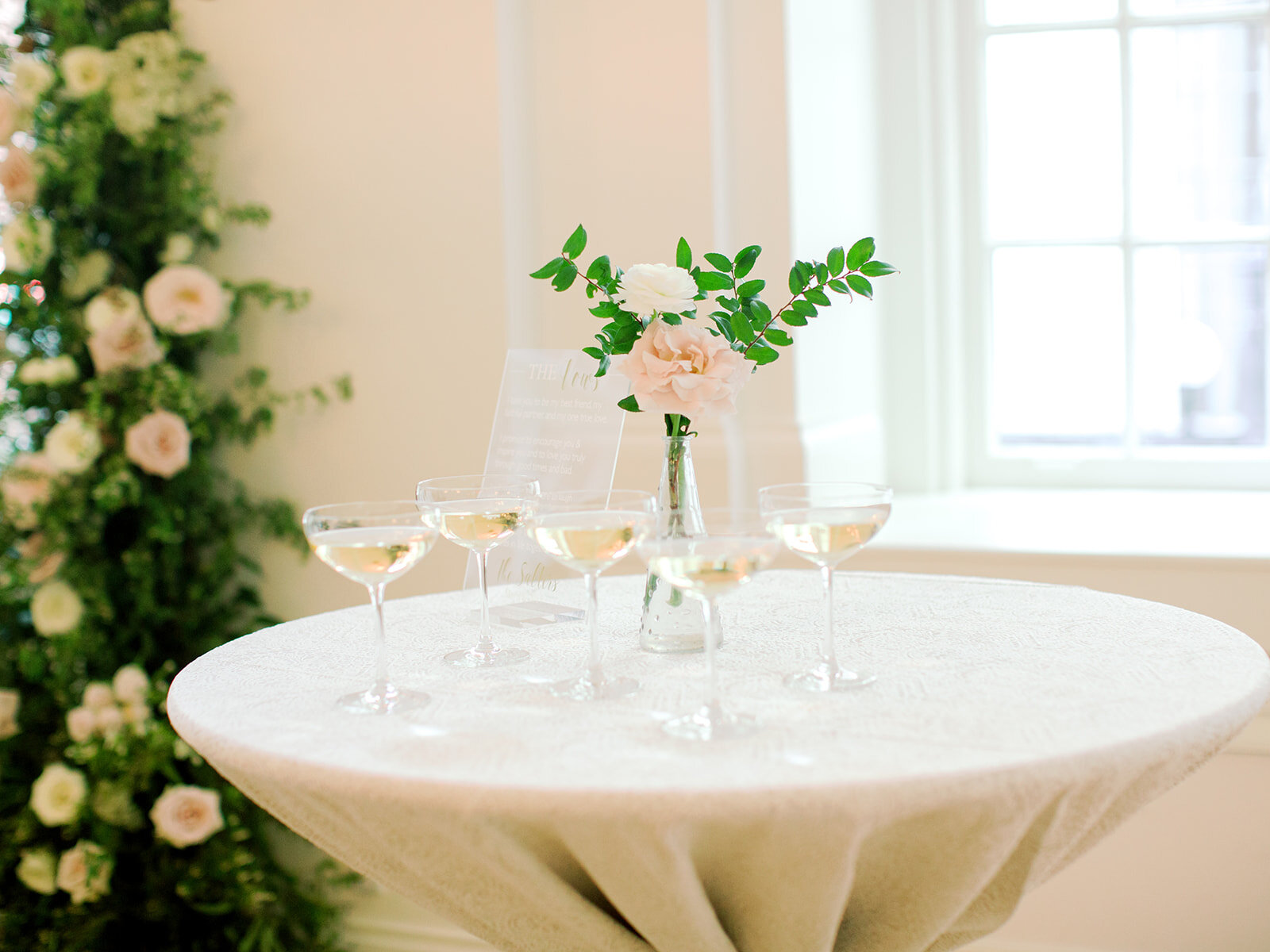 Simple blush flower bud vase with champagne. Nashville wedding florist.