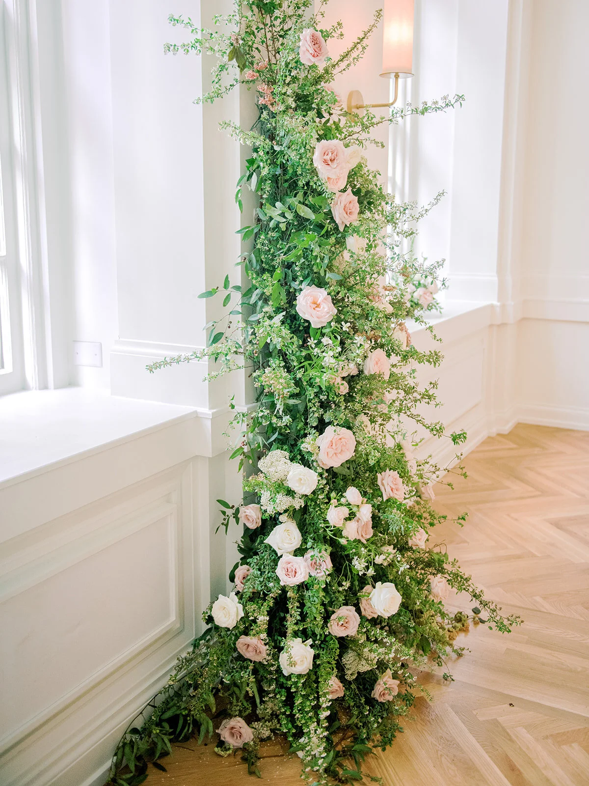 Asymmetrical floral installation growing up either side of the windows in the Noelle. Nashville Wedding Florist.