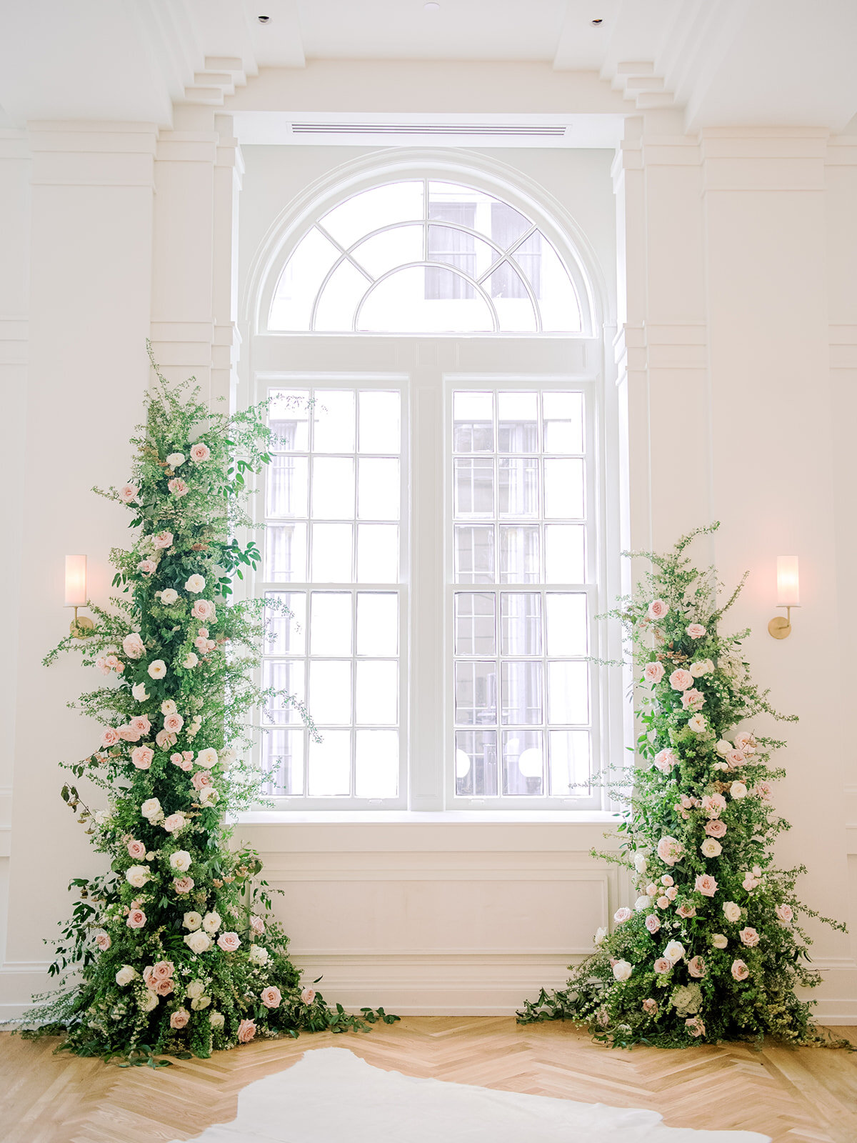 Asymmetrical floral installation growing up either side of the windows in the Noelle. Nashville Wedding Florist.