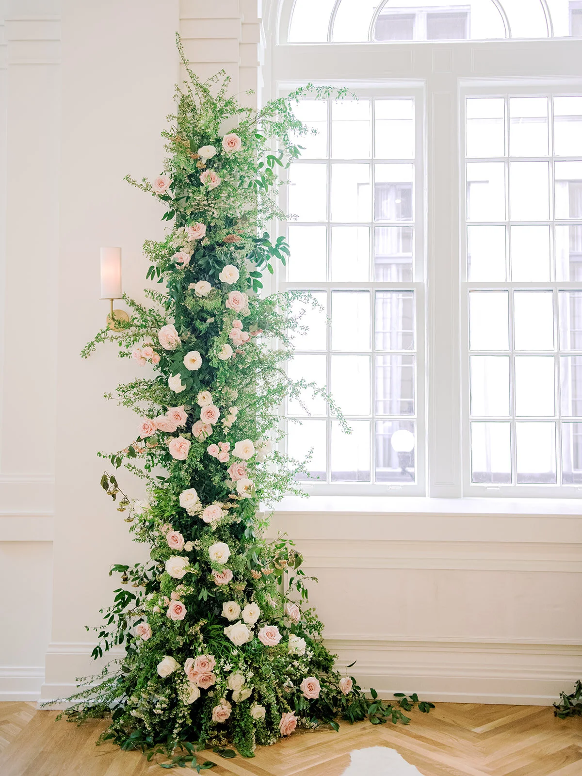 Asymmetrical floral installation growing up either side of the windows in the Noelle. Nashville Wedding Florist.