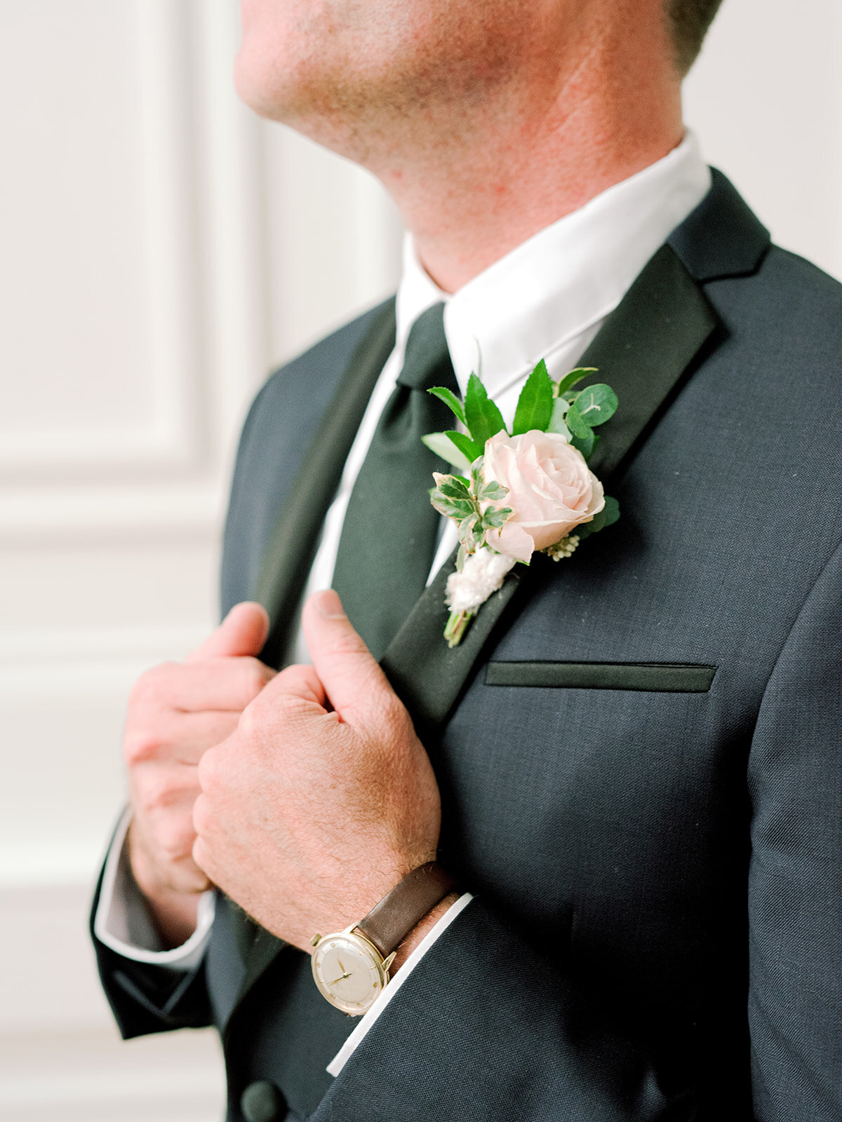 Blush and ivory groom’s boutonniere with texture and natural greenery. Nashville wedding florist.